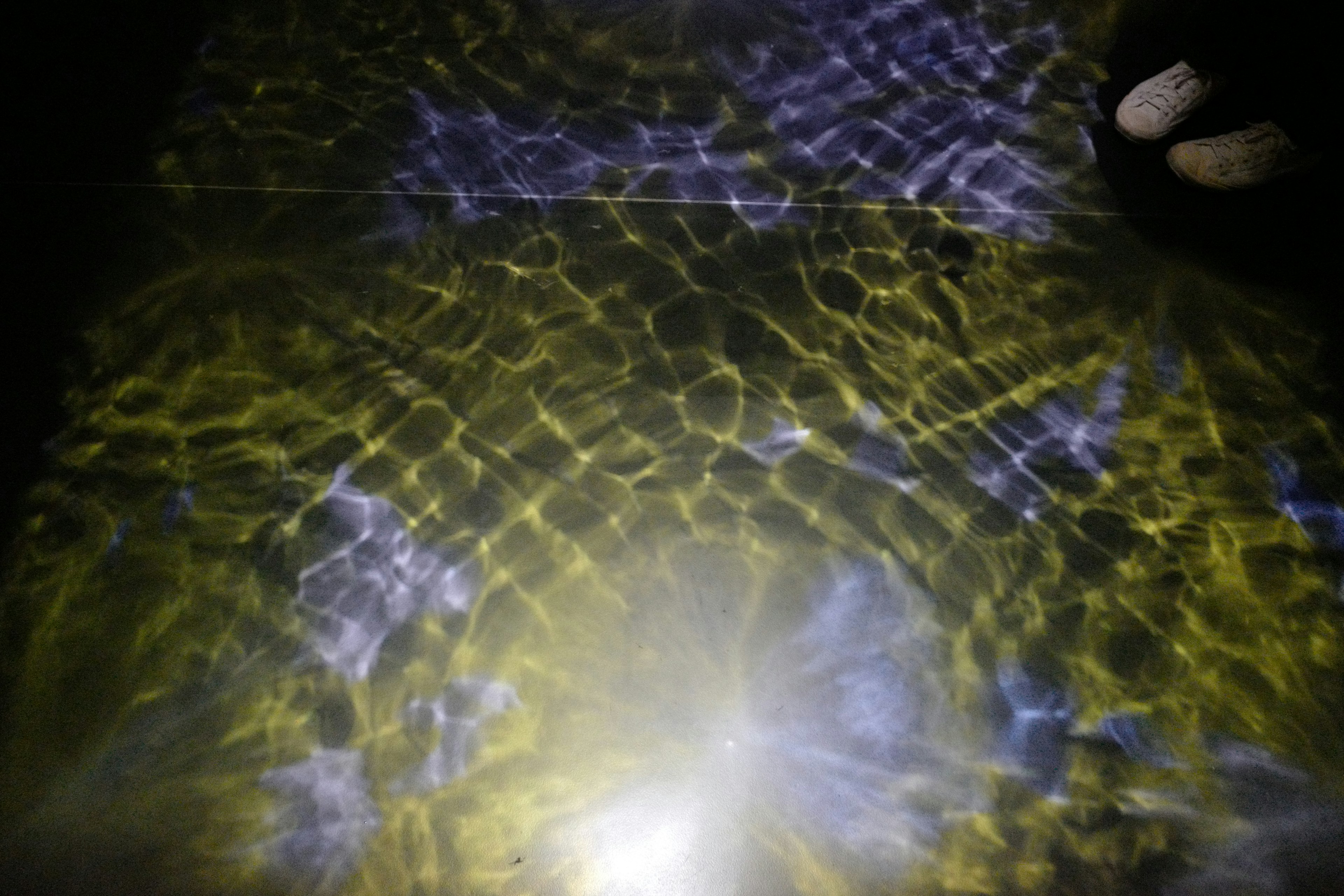 Beautiful reflections of yellow and purple light on water surface