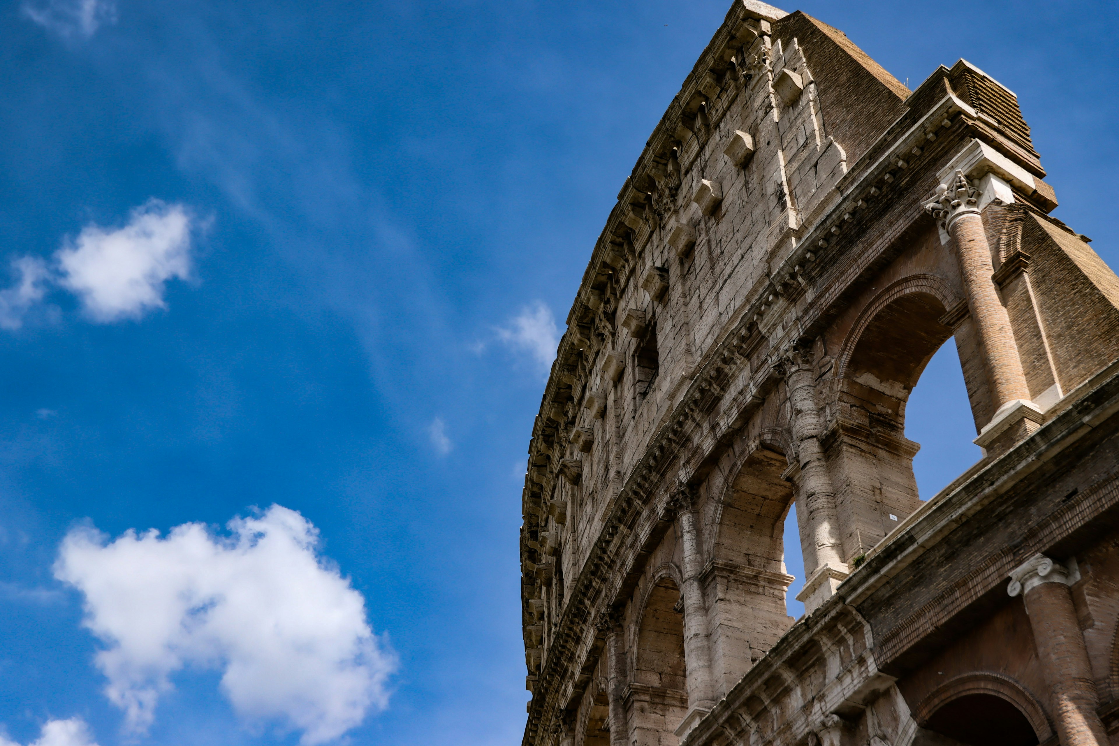 Side view of the Colosseum with a blue sky