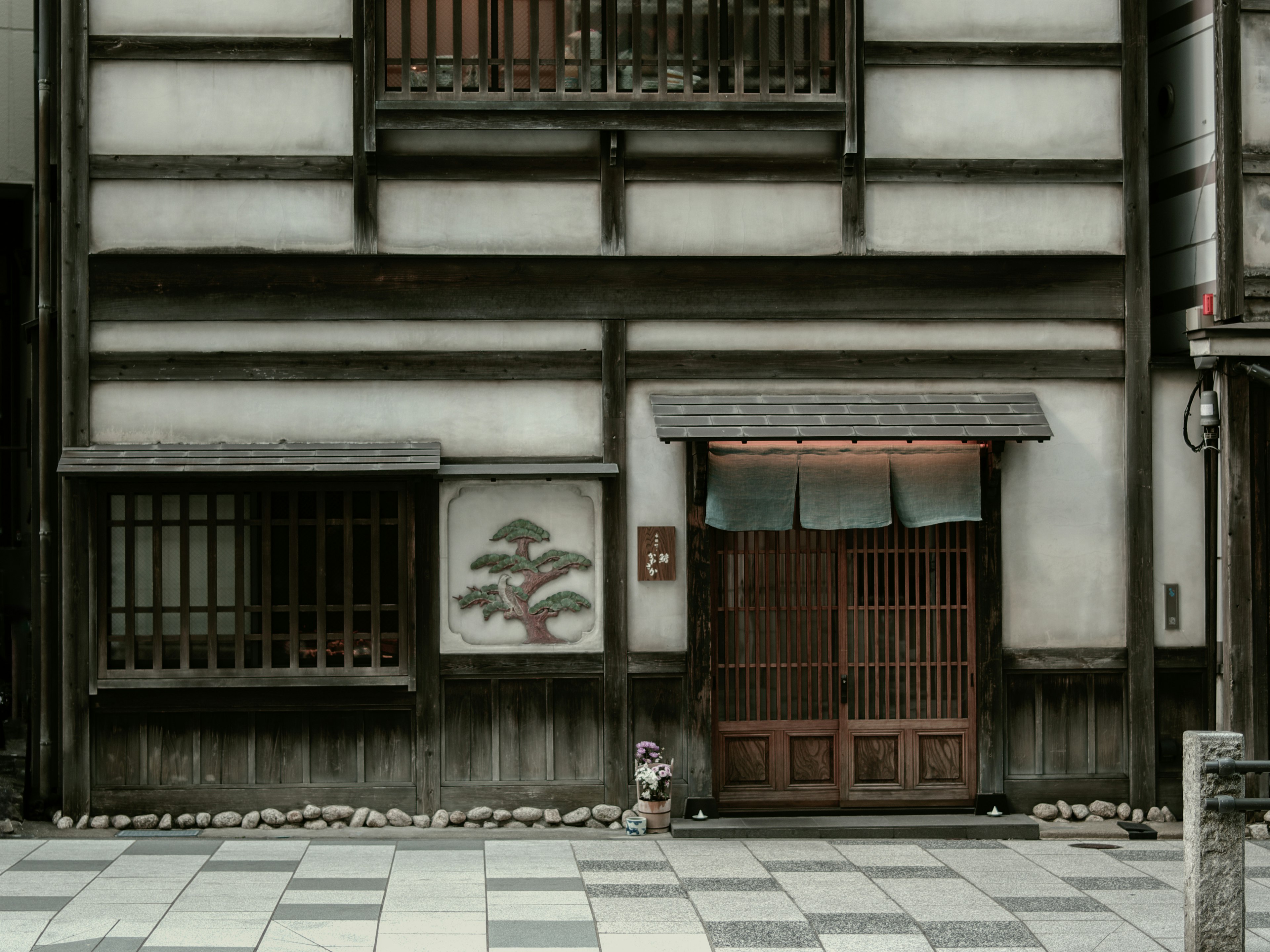 Traditional Japanese house exterior with stone pavement