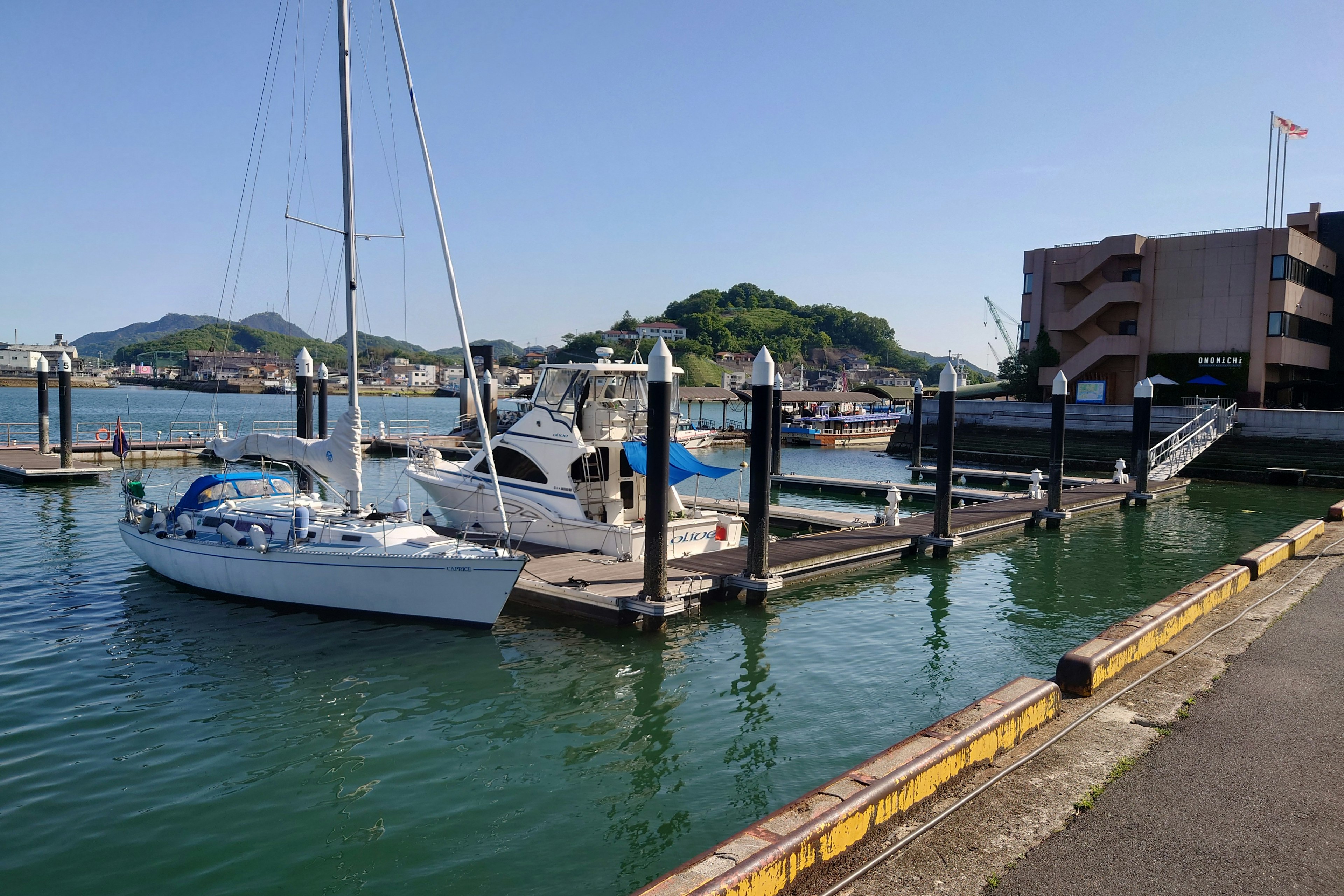 A serene harbor scene with a yacht docked at a marina