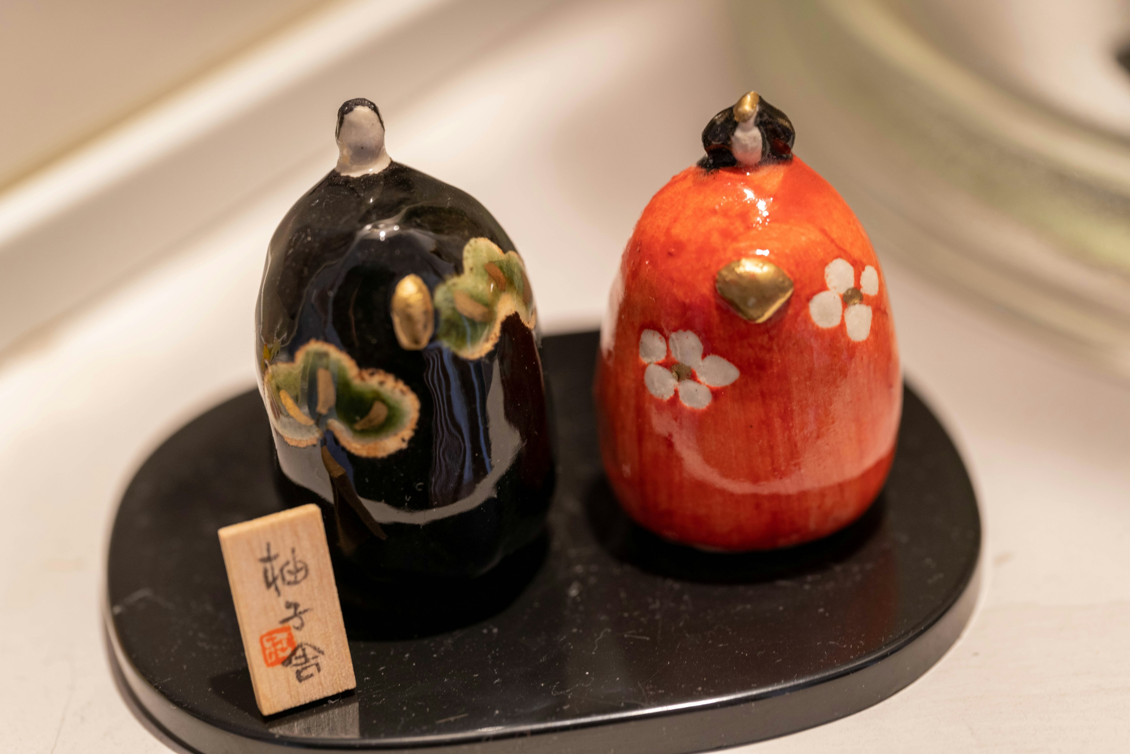 Traditional Japanese dolls in black and red colors displayed together