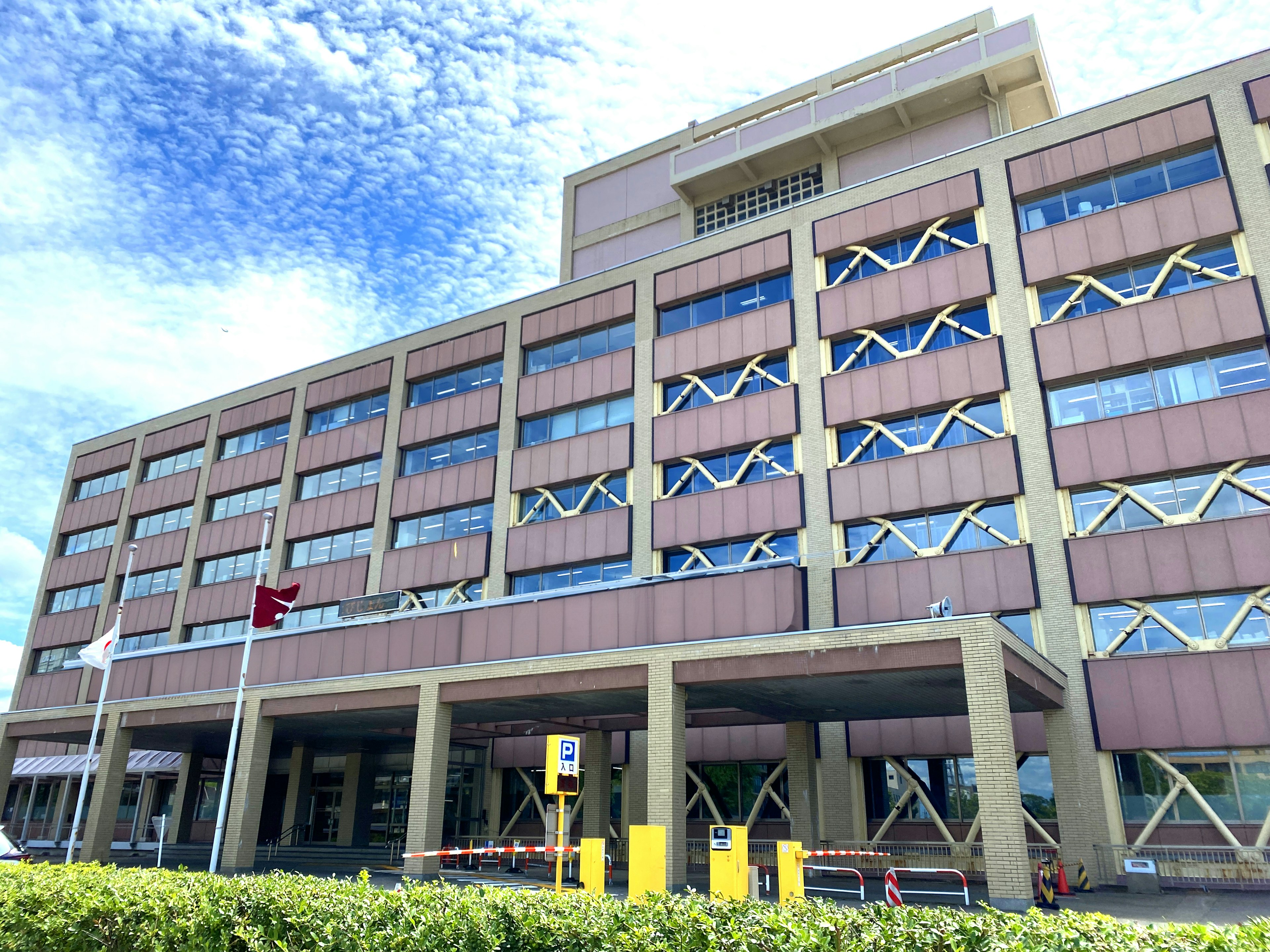 Modern building exterior with unique window design under blue sky