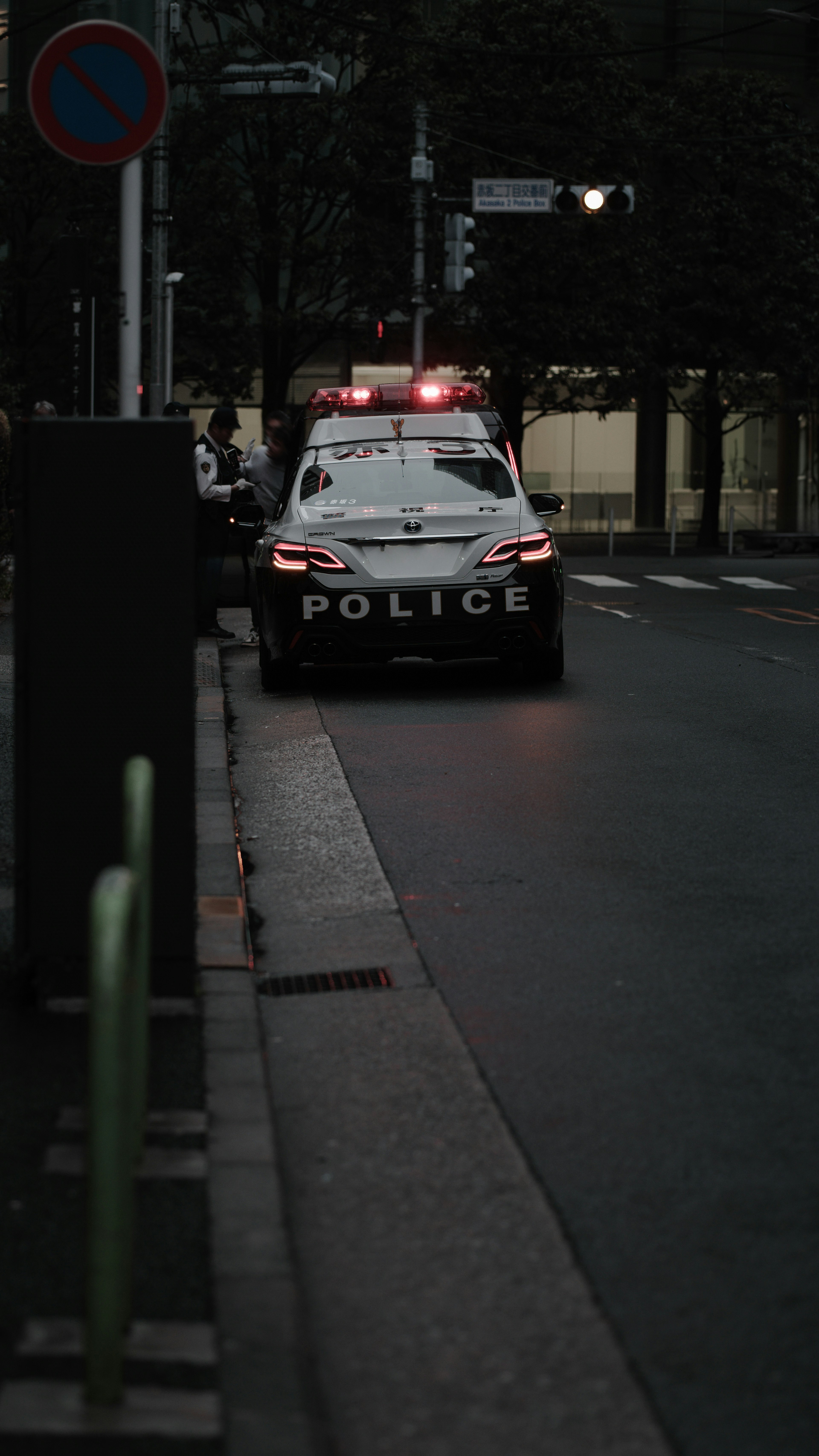 Police car parked on a street at night