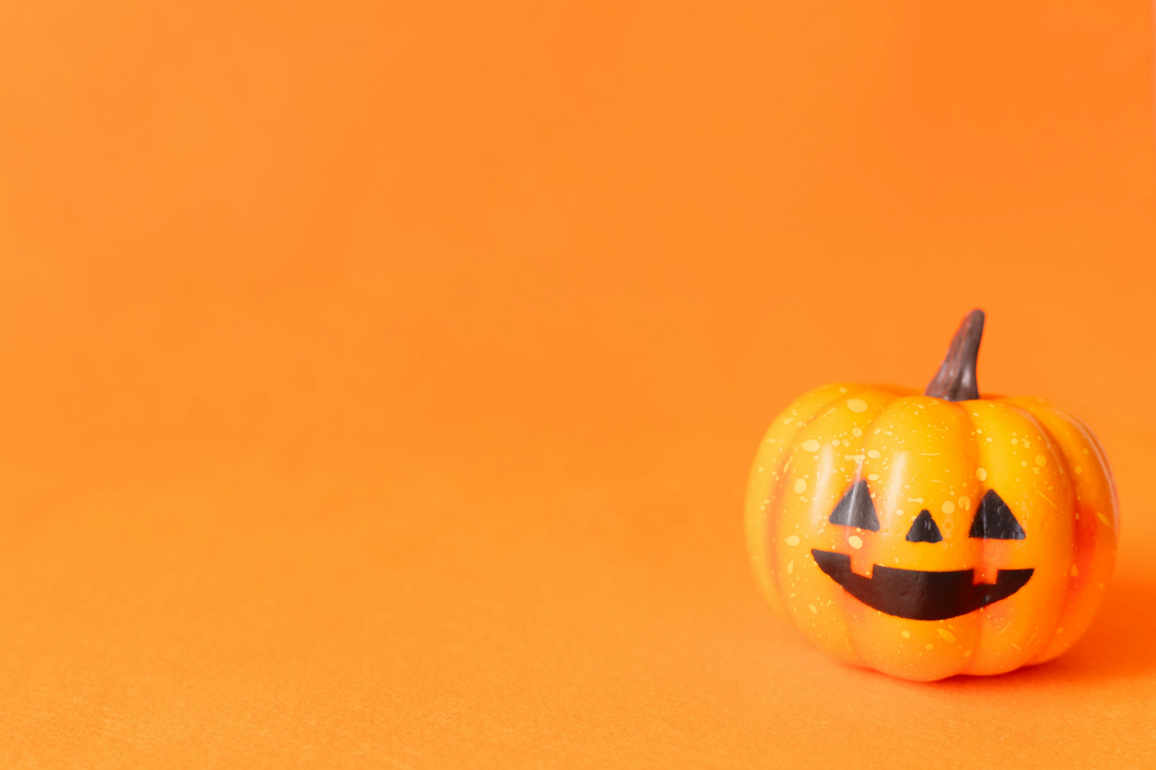 Smiling Jack-o'-lantern on an orange background