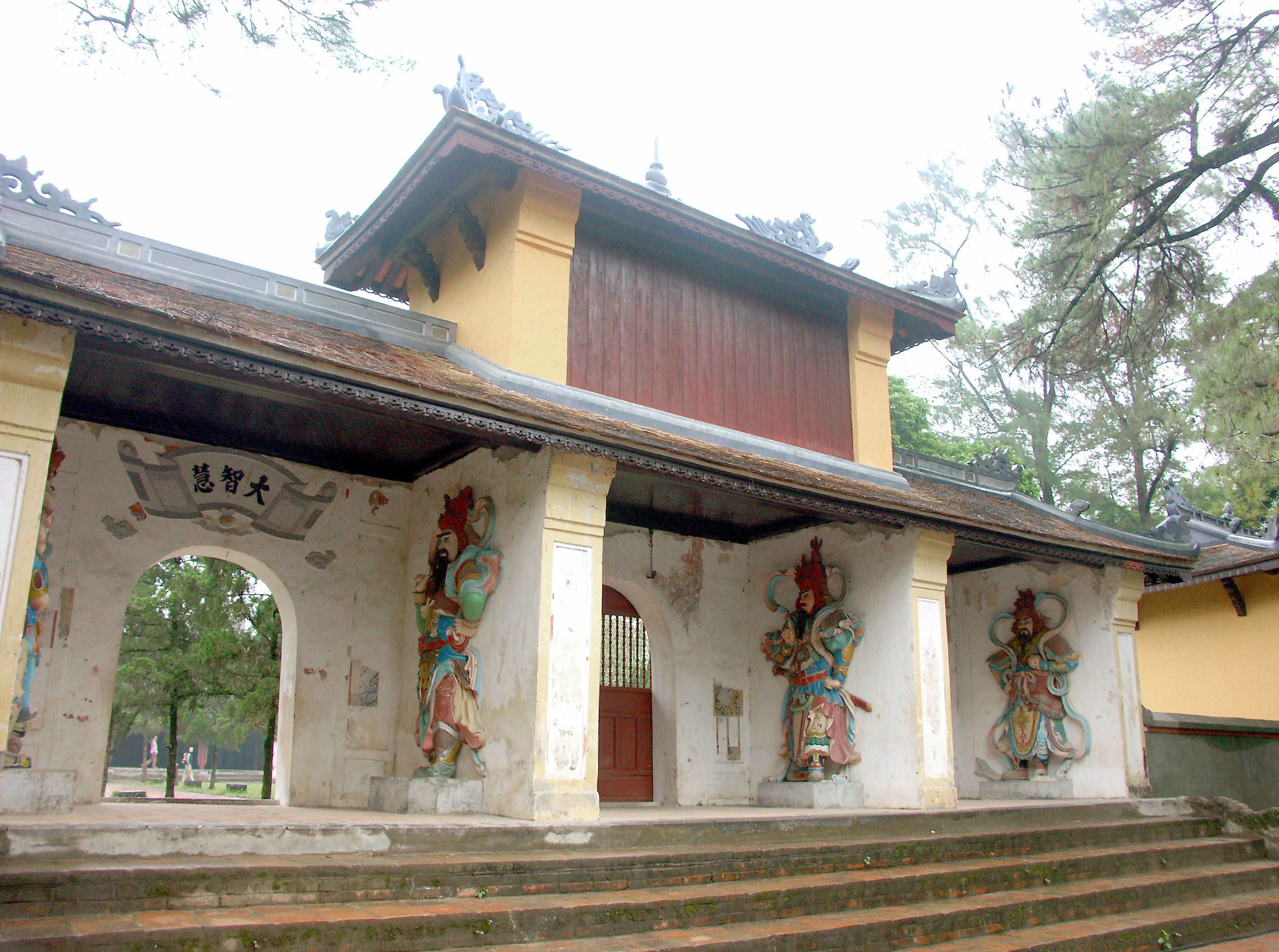 Entrada de un hermoso templo con murales coloridos en los pilares