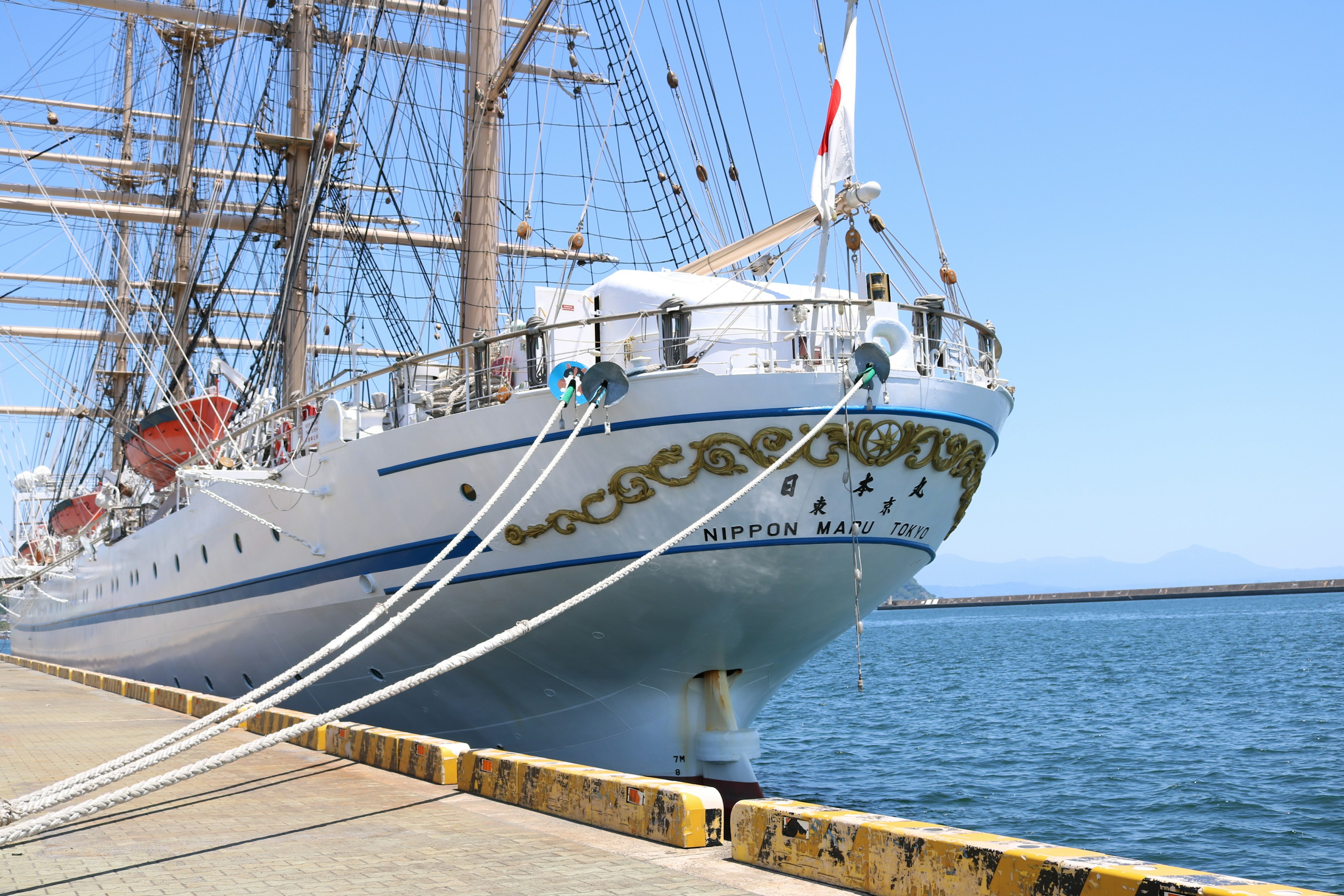 A beautifully decorated tall ship docked at the harbor