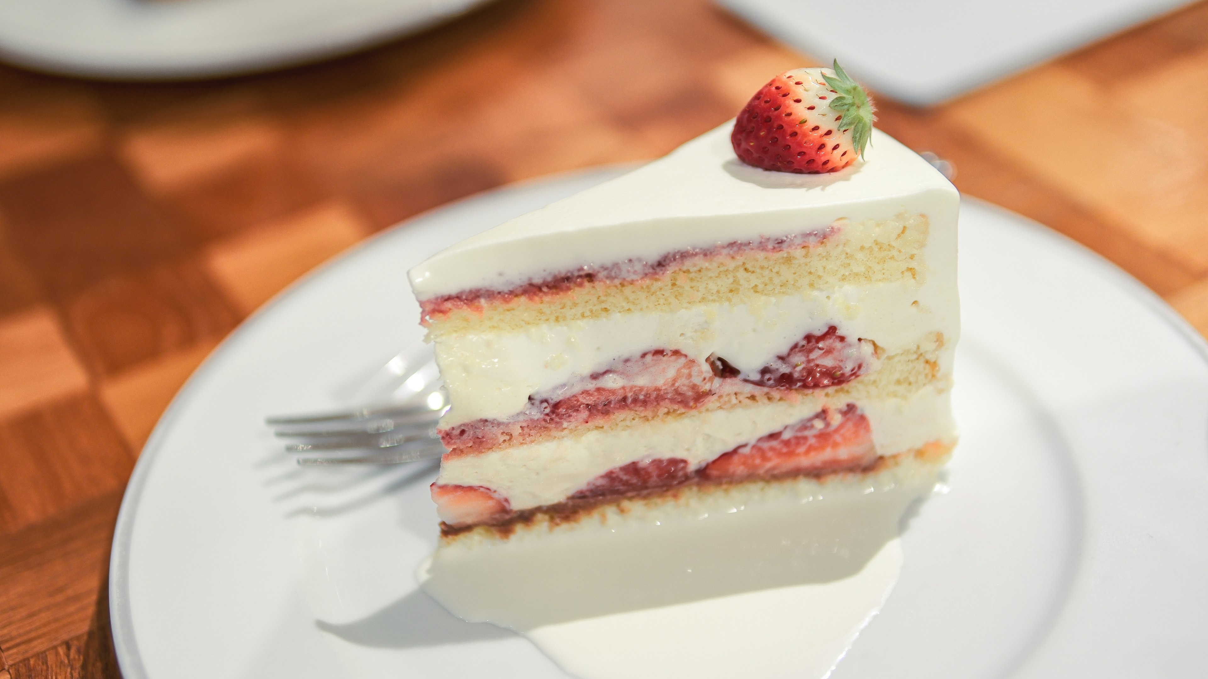 Slice of cake with cream and strawberries layered