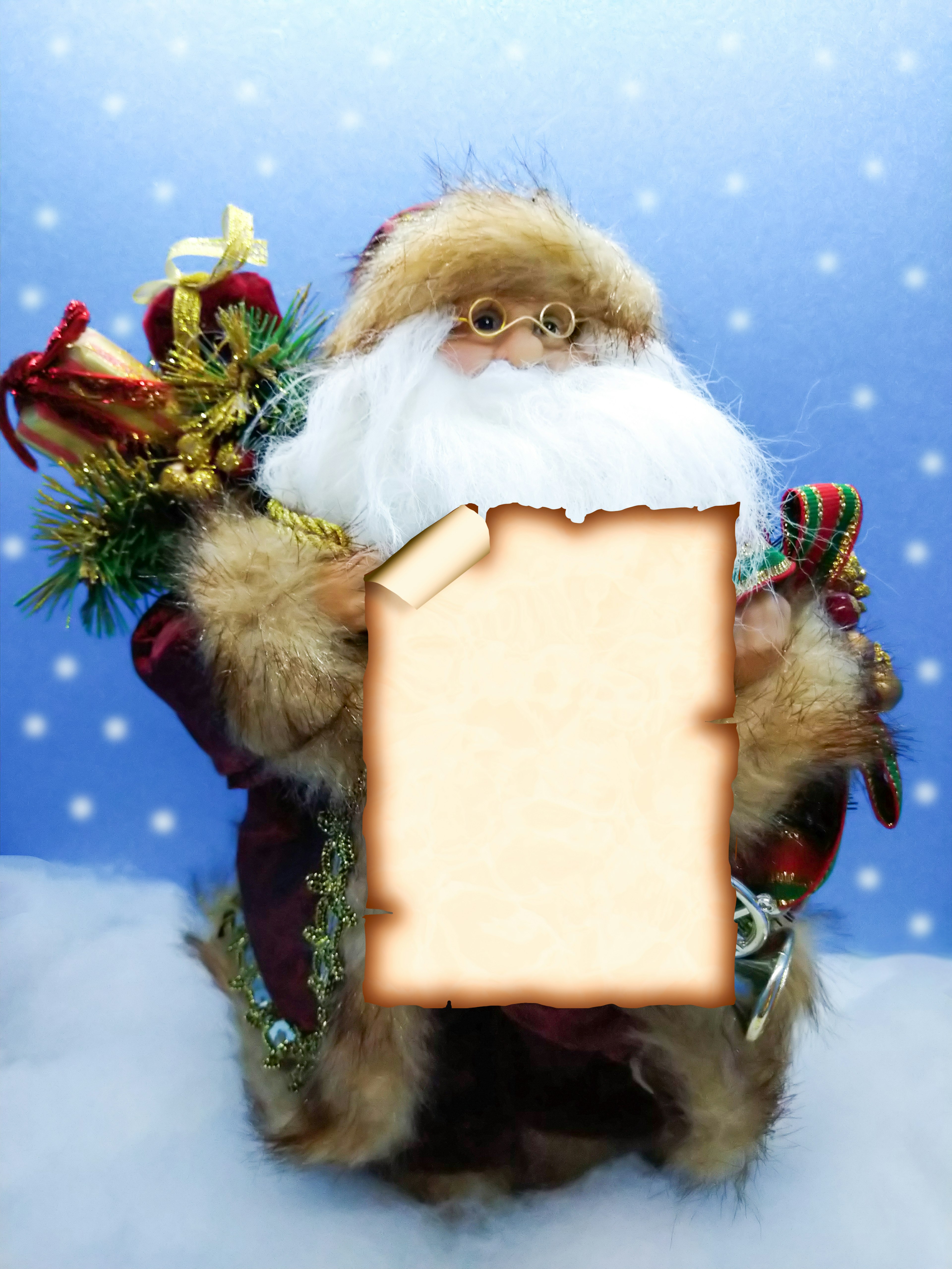 Santa Claus figure holding a blank parchment