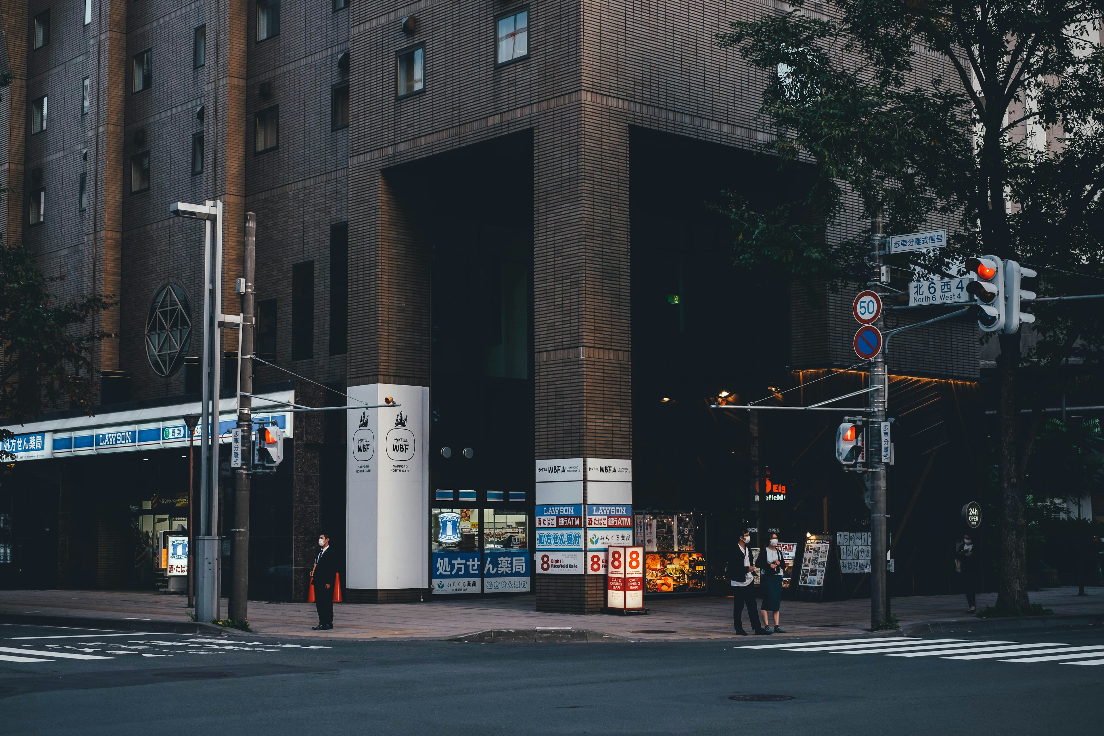 Night view of a street corner with a building and traffic lights