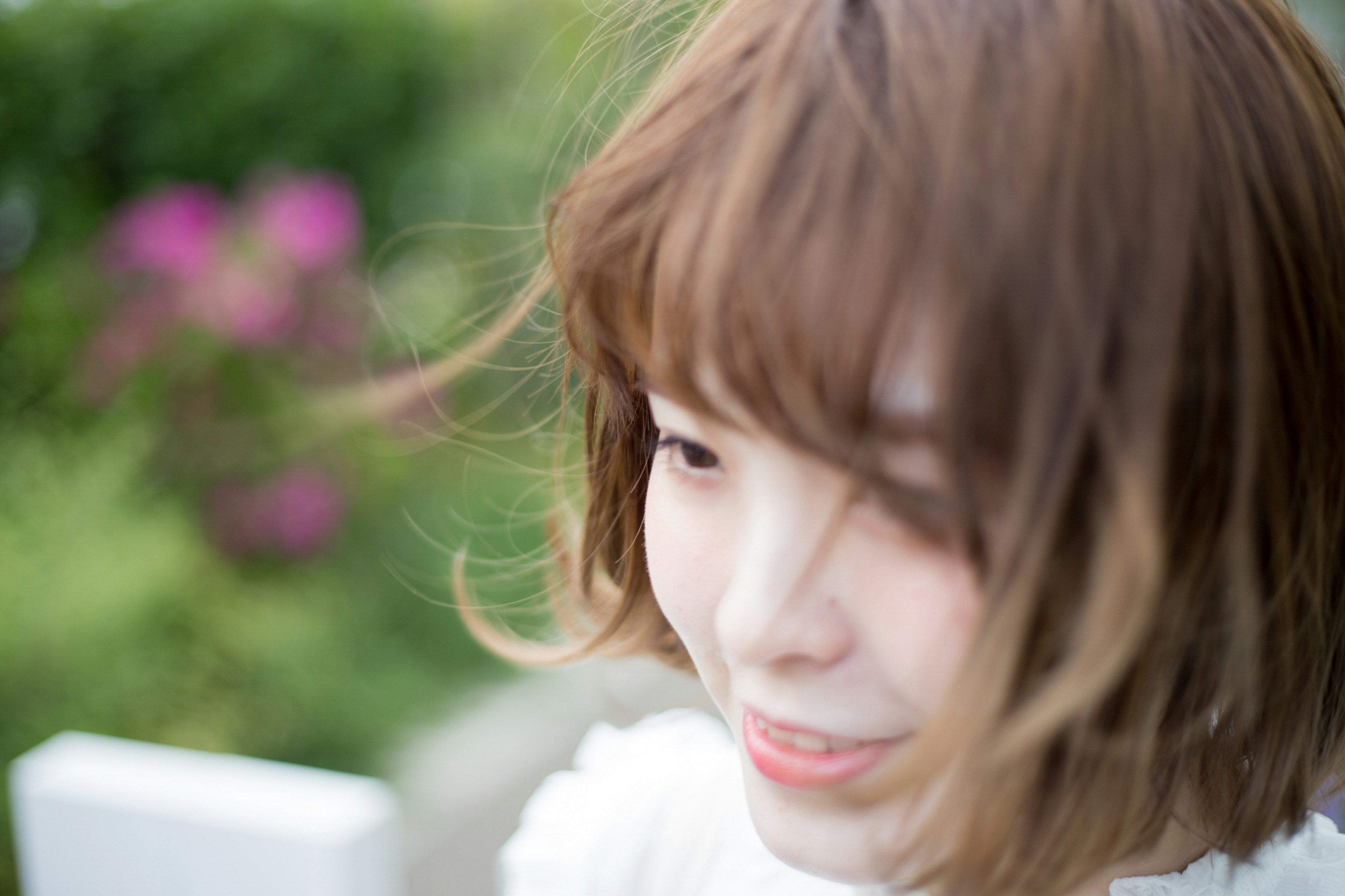 Young woman smiling with wind-blown hair outdoors