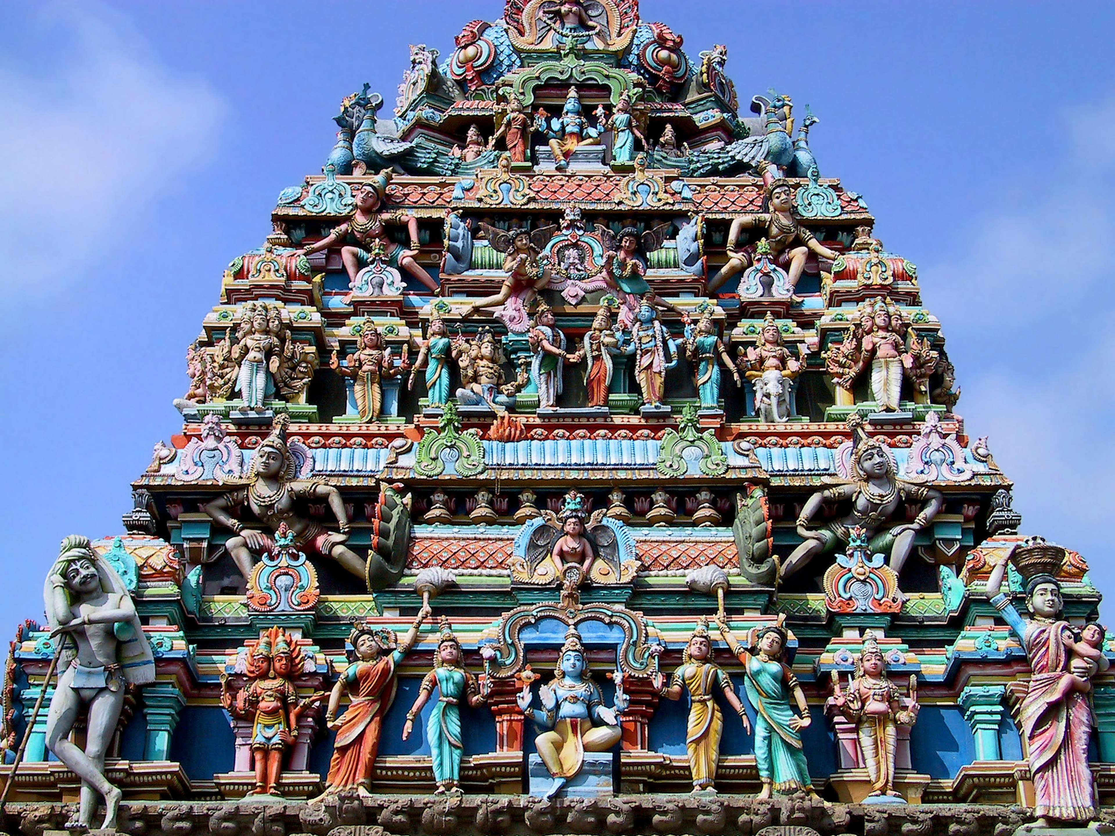 Colorful sculptures adorning the tower of an Indian temple