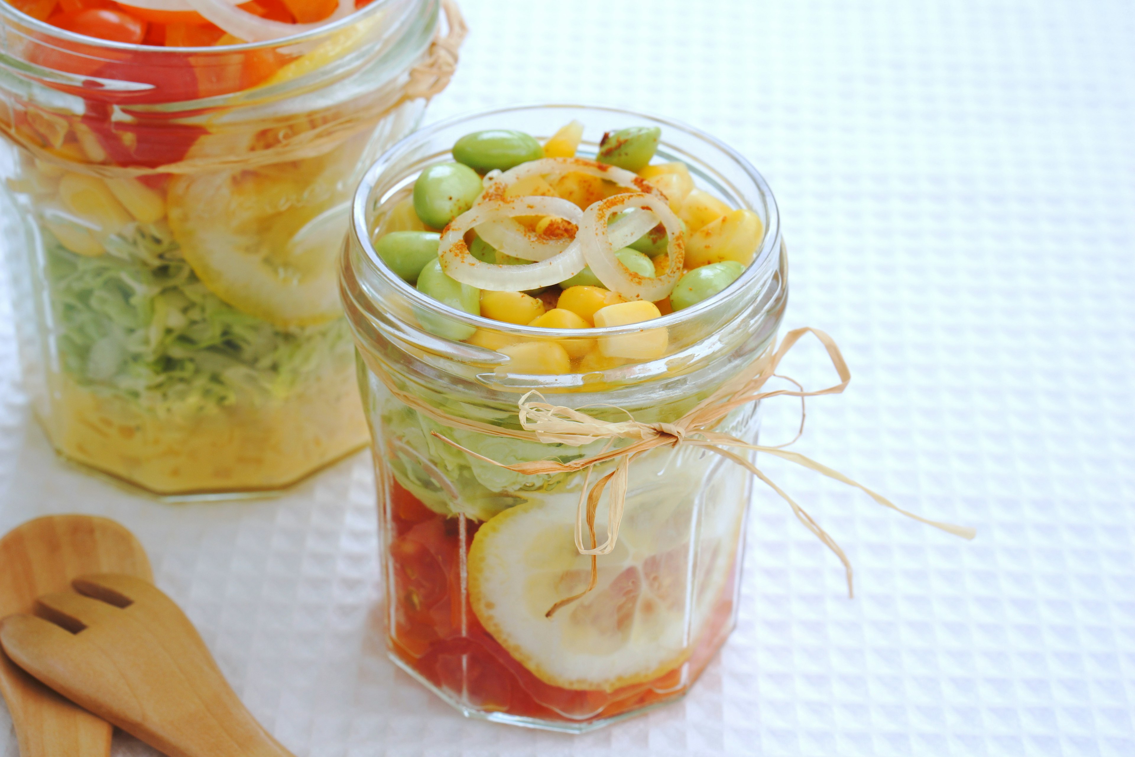 Colorful layered salad in a glass jar