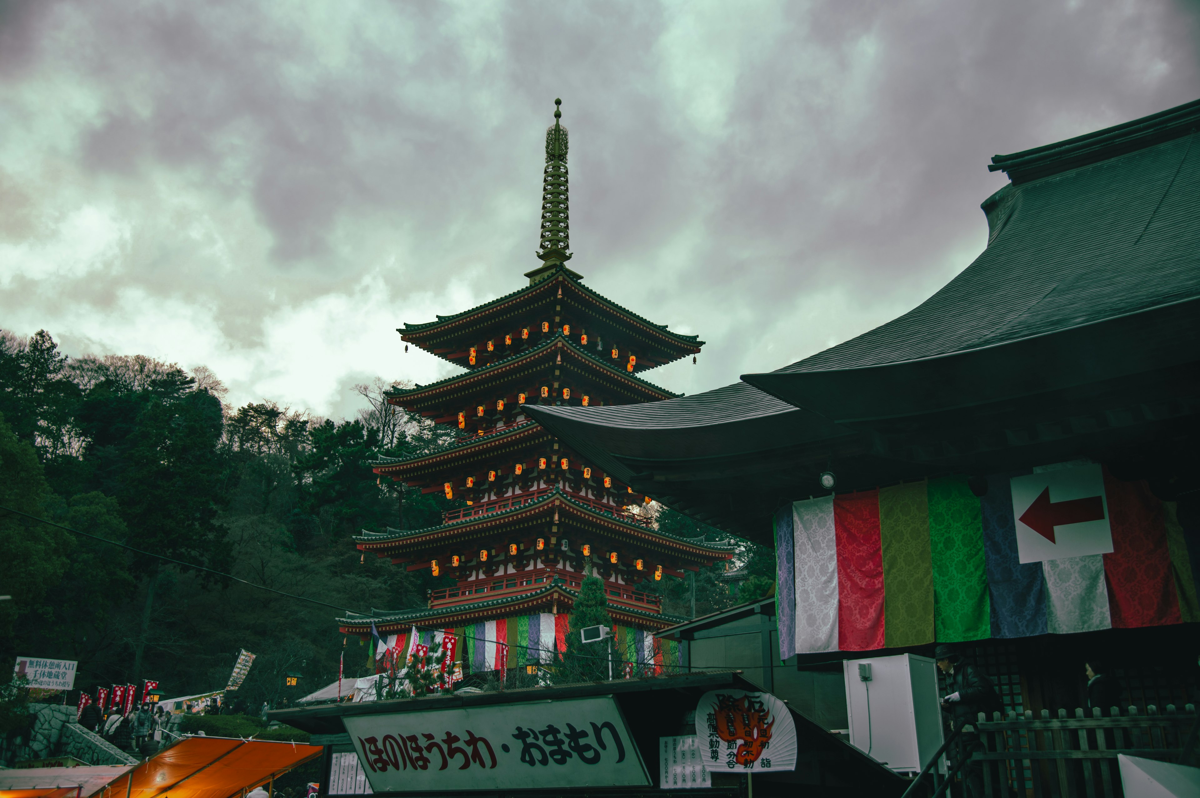 Pagoda and traditional building under a cloudy sky