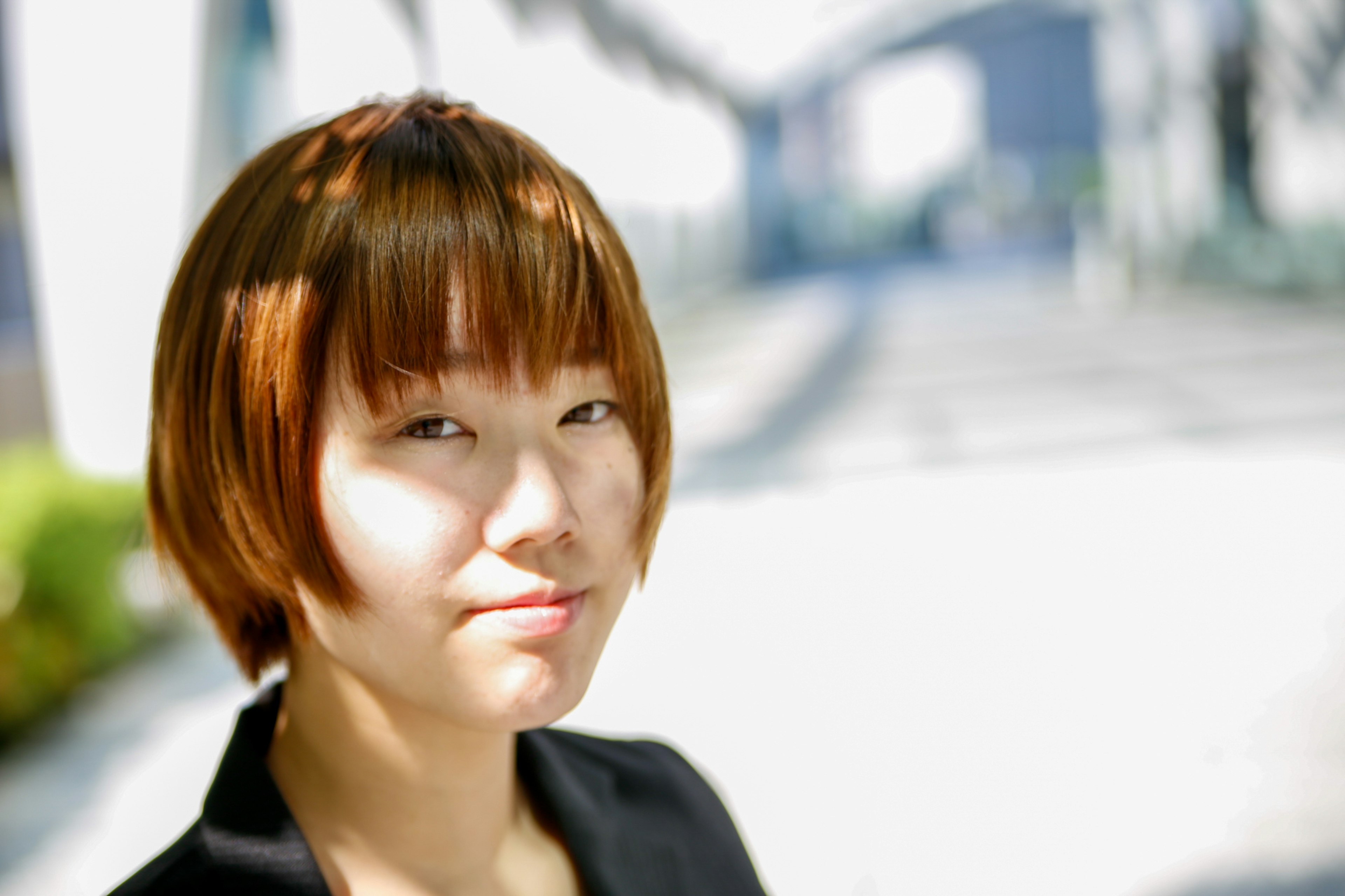 Portrait of a woman smiling against a bright background