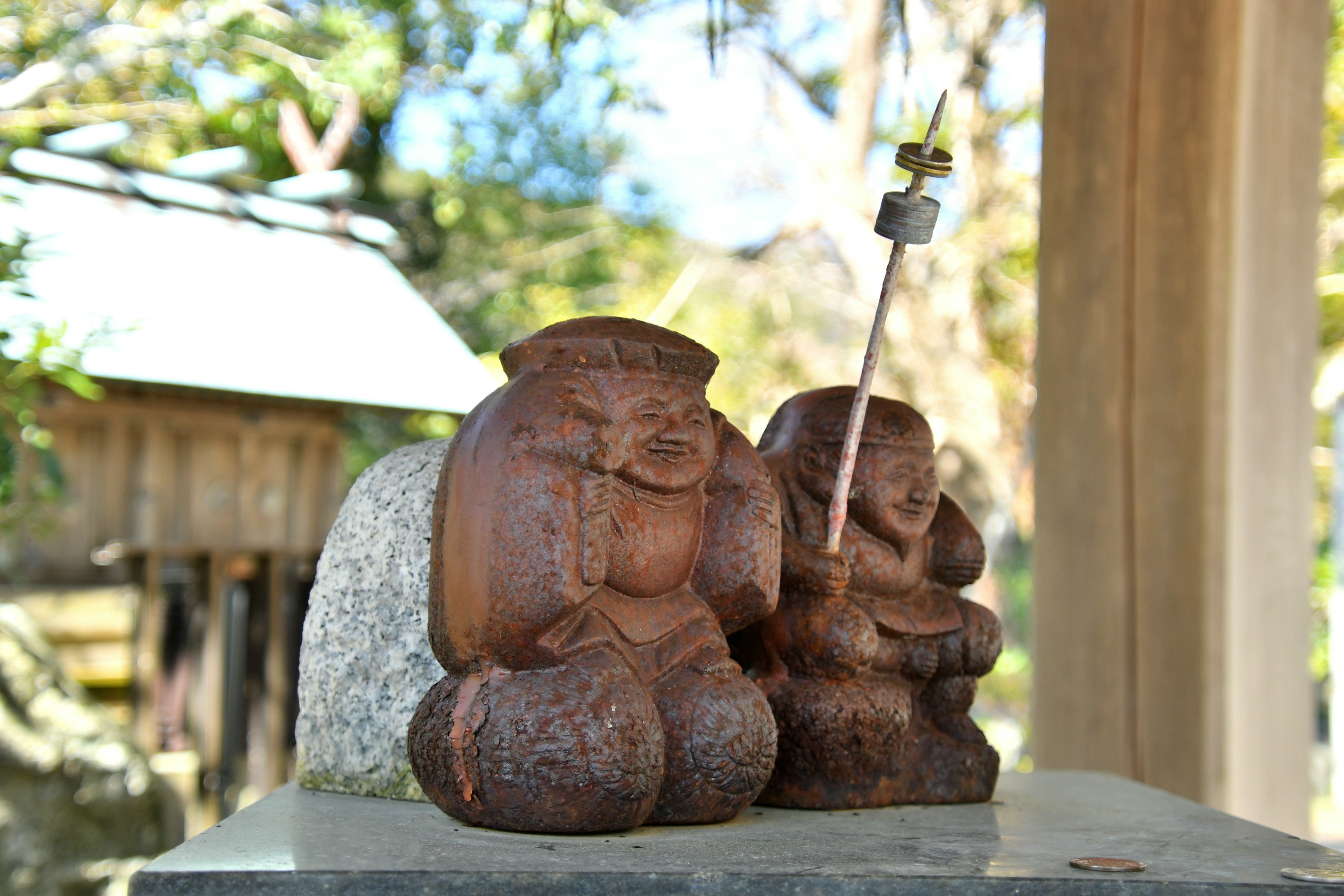 Two wooden carved statues placed side by side