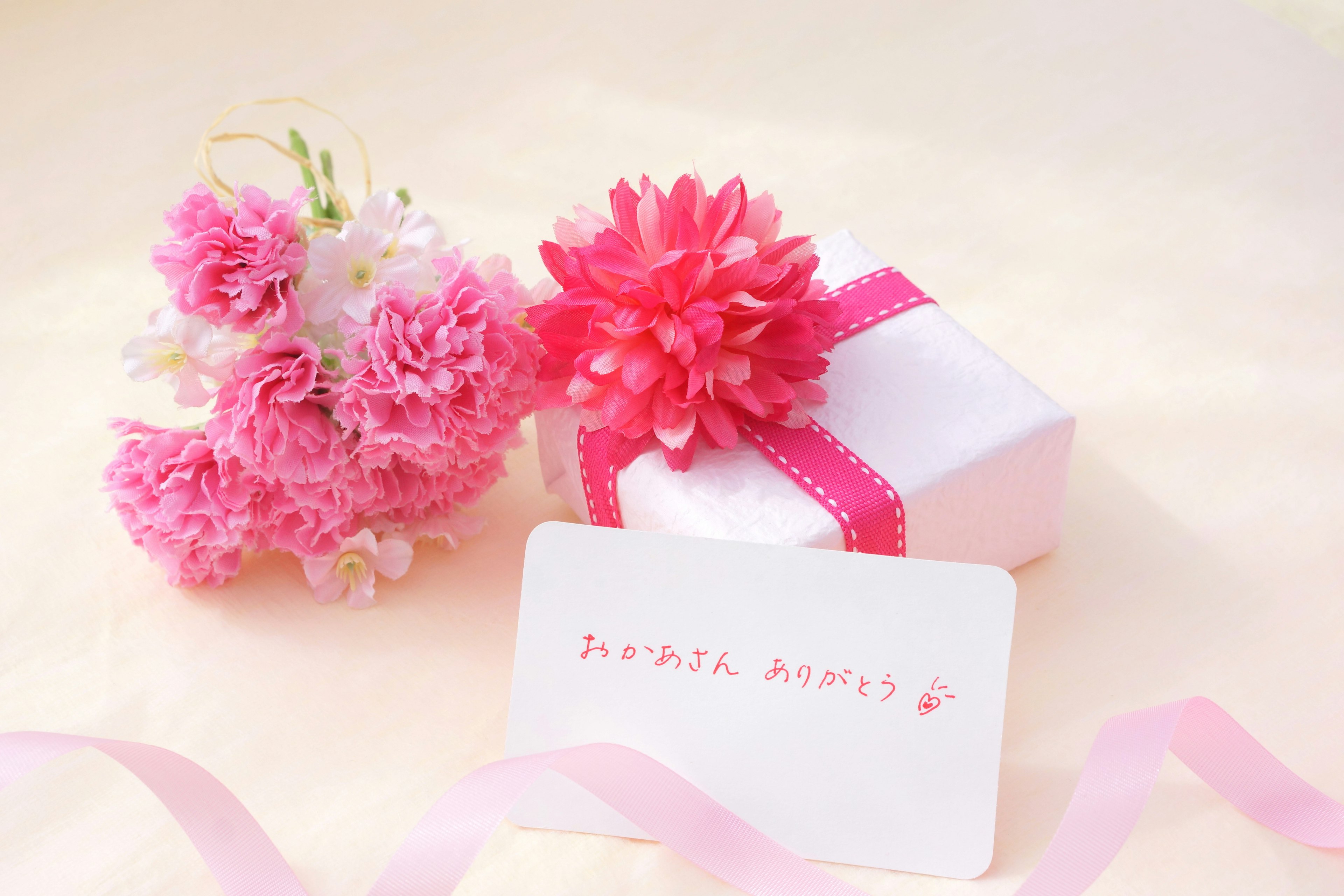 Image of a small gift box wrapped in pink with flowers and a card