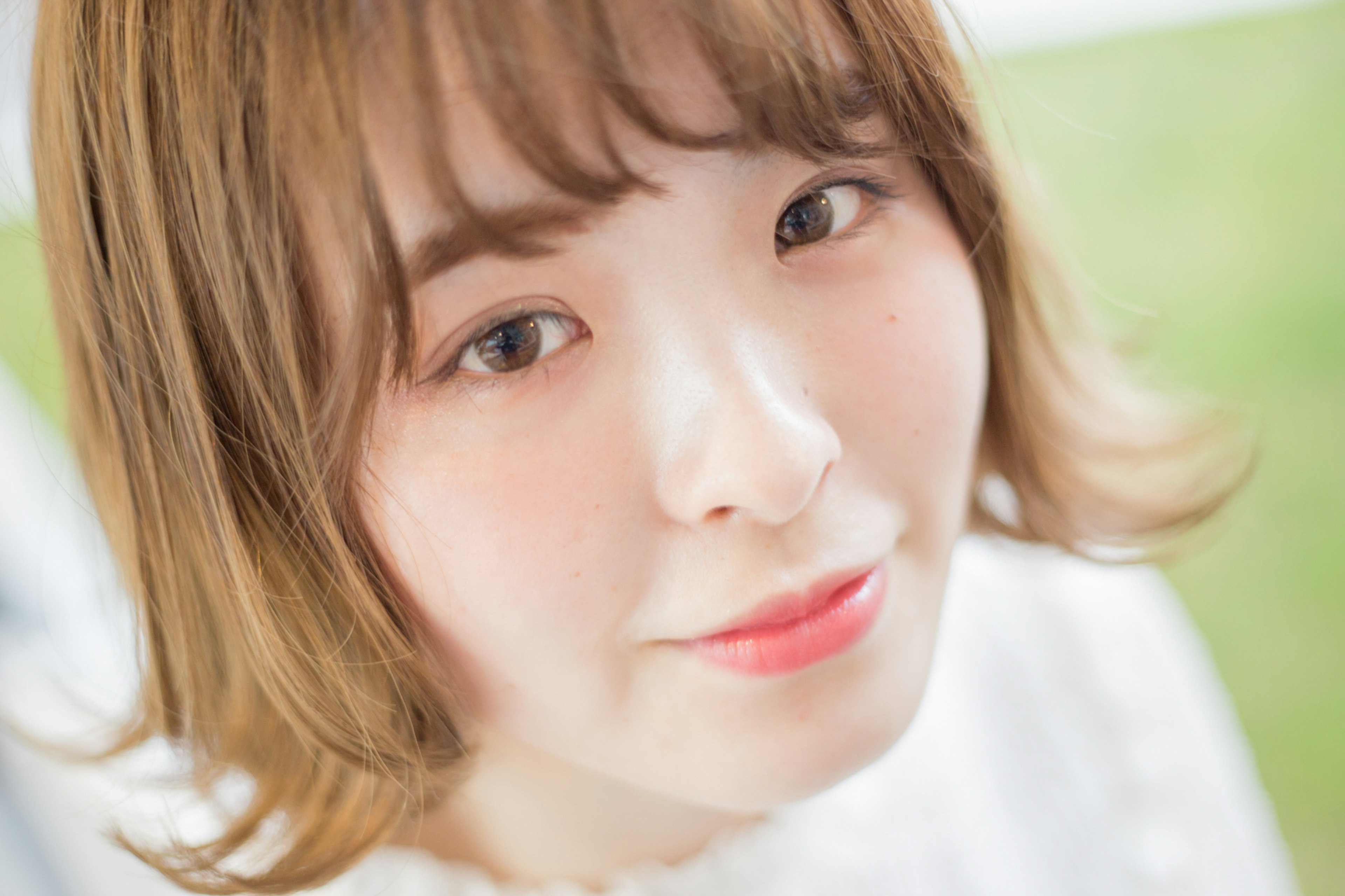 Portrait of a young woman smiling with soft hairstyle and bright background