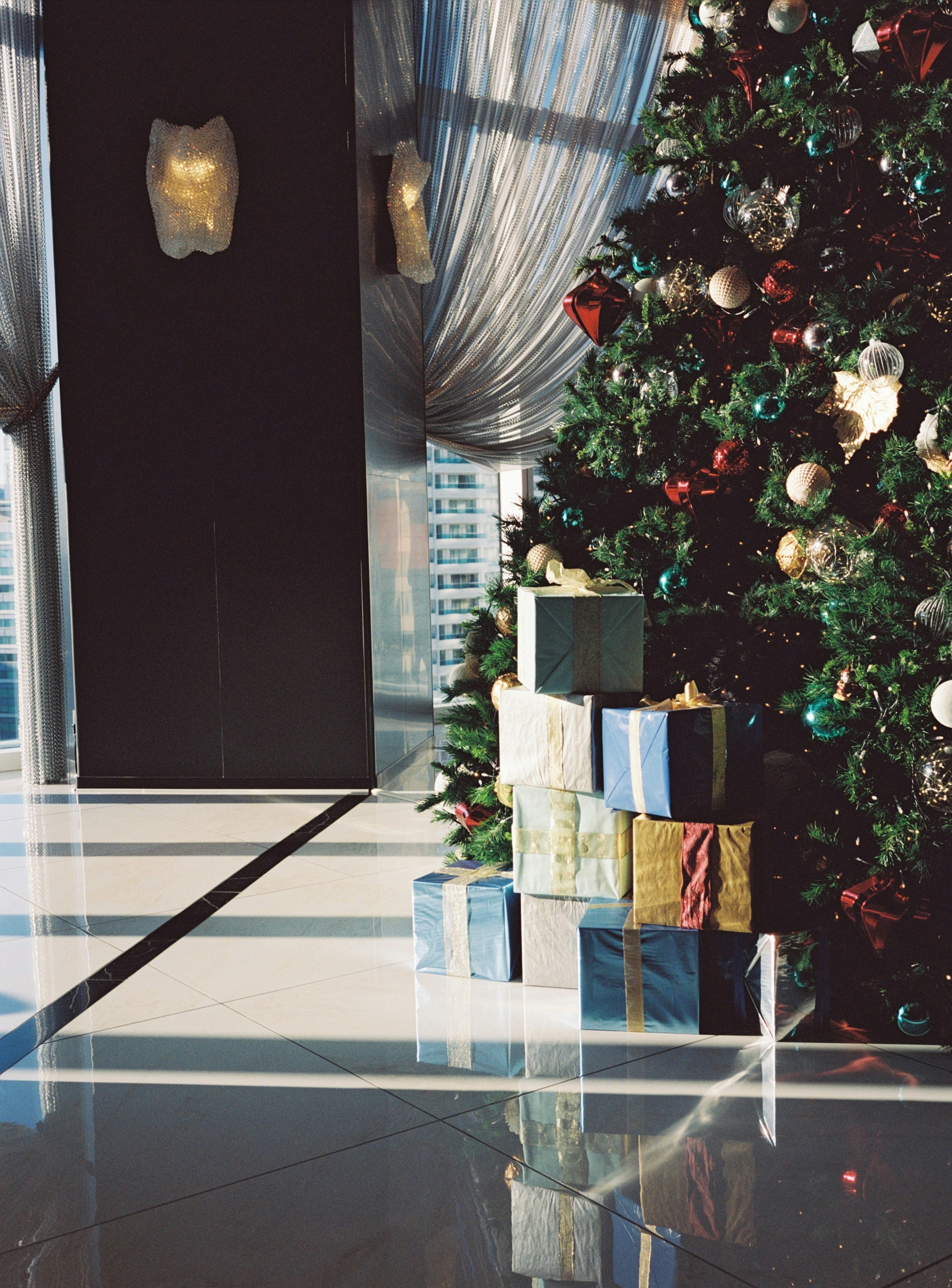 Luxurious interior featuring a Christmas tree and colorful presents