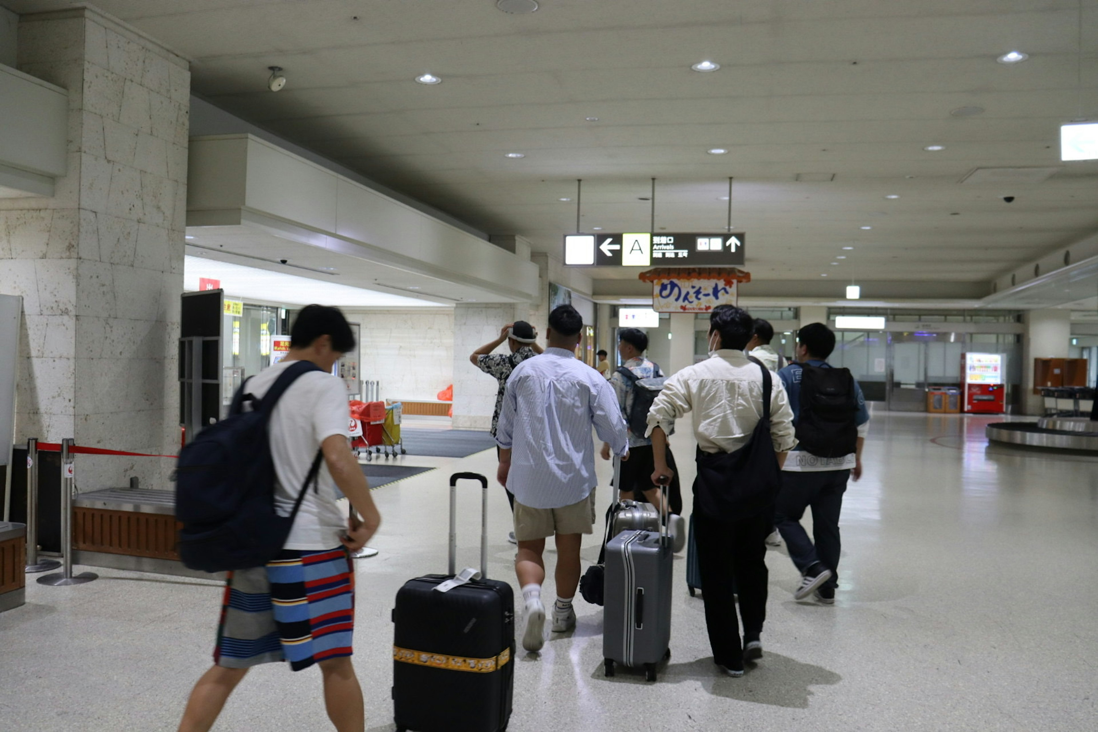 Group of travelers walking through an airport lobby