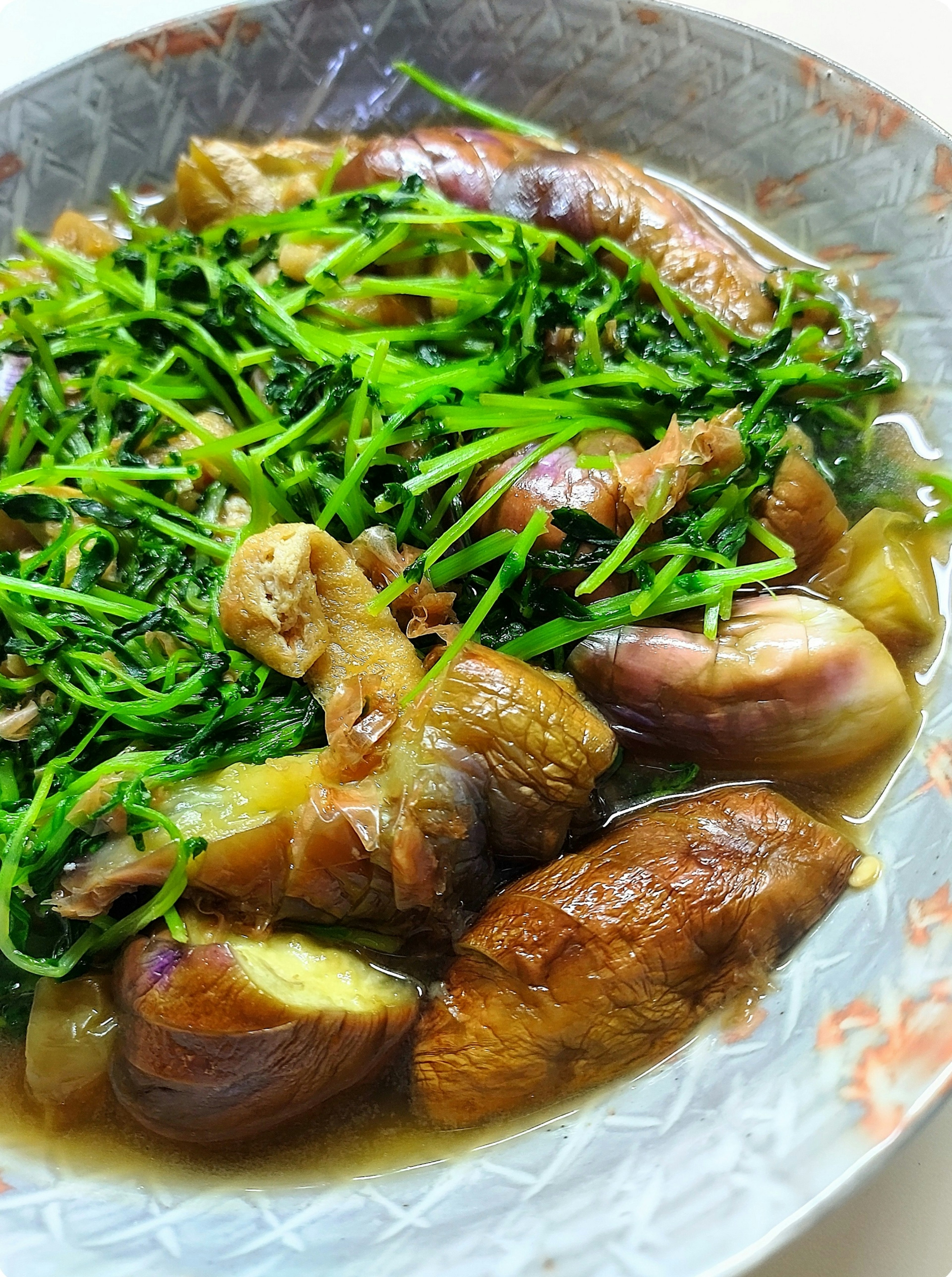 A dish of stewed chicken and vegetables served in a decorative bowl