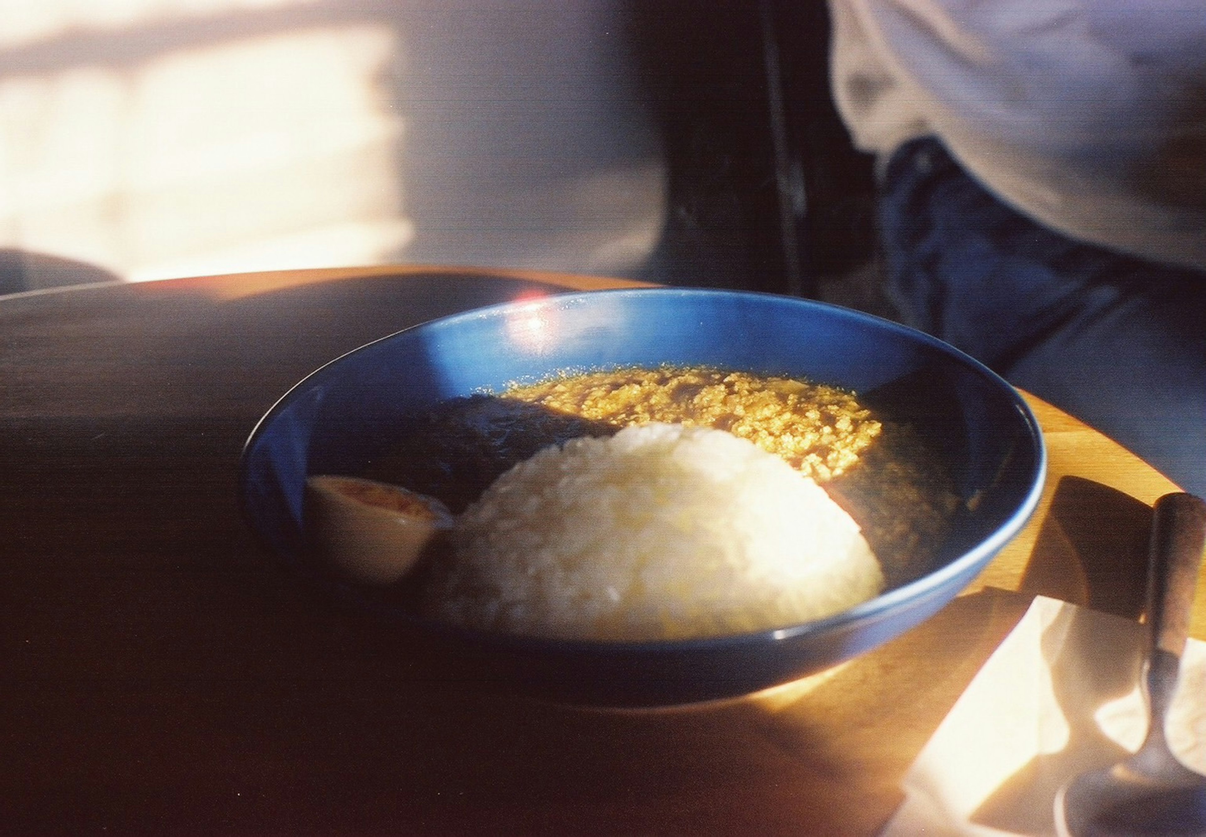 A blue bowl filled with rice and lentils