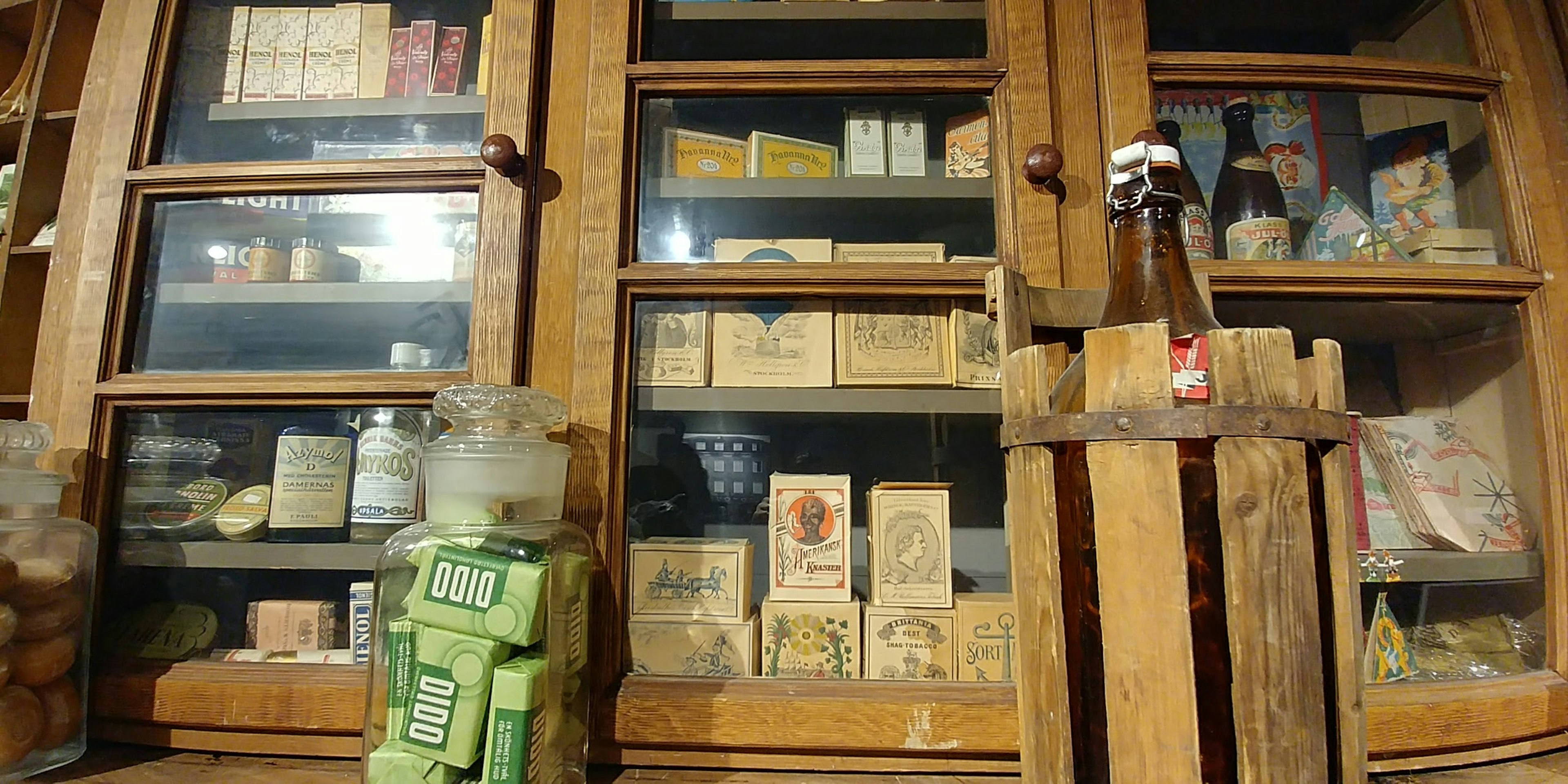 Various food packages and jars displayed on an old wooden shelf