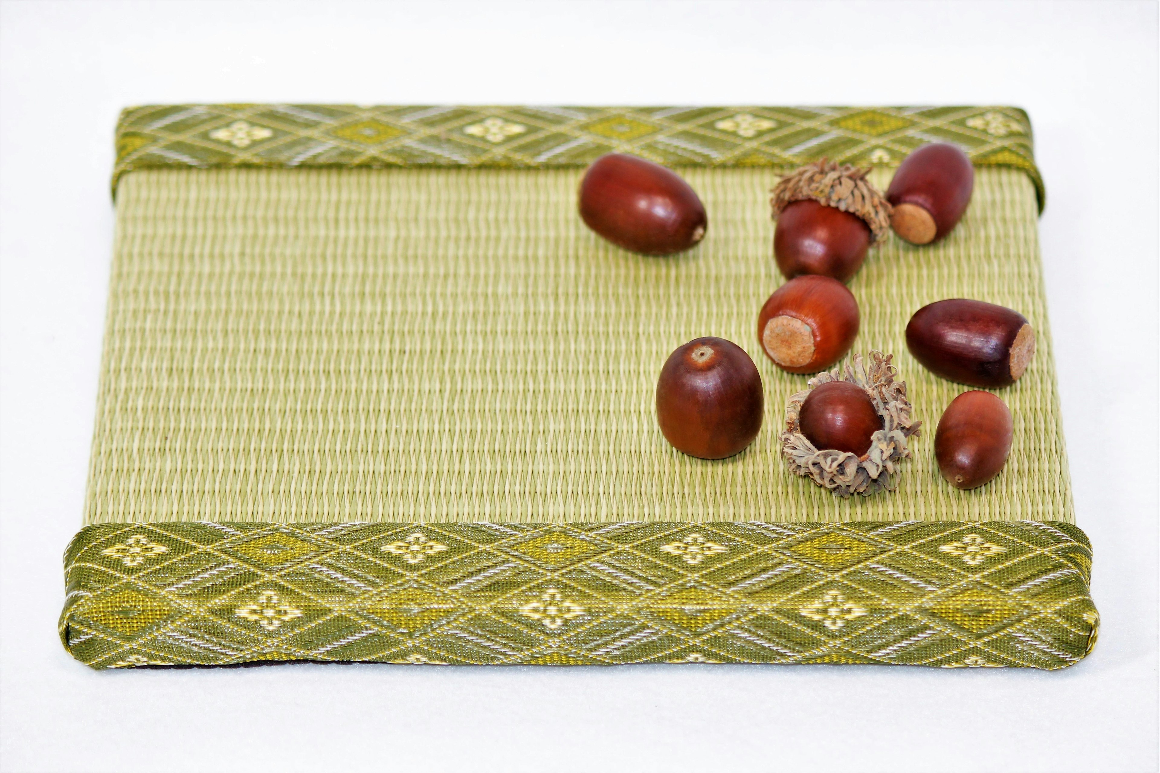 Various types of acorns placed on a decorative green mat