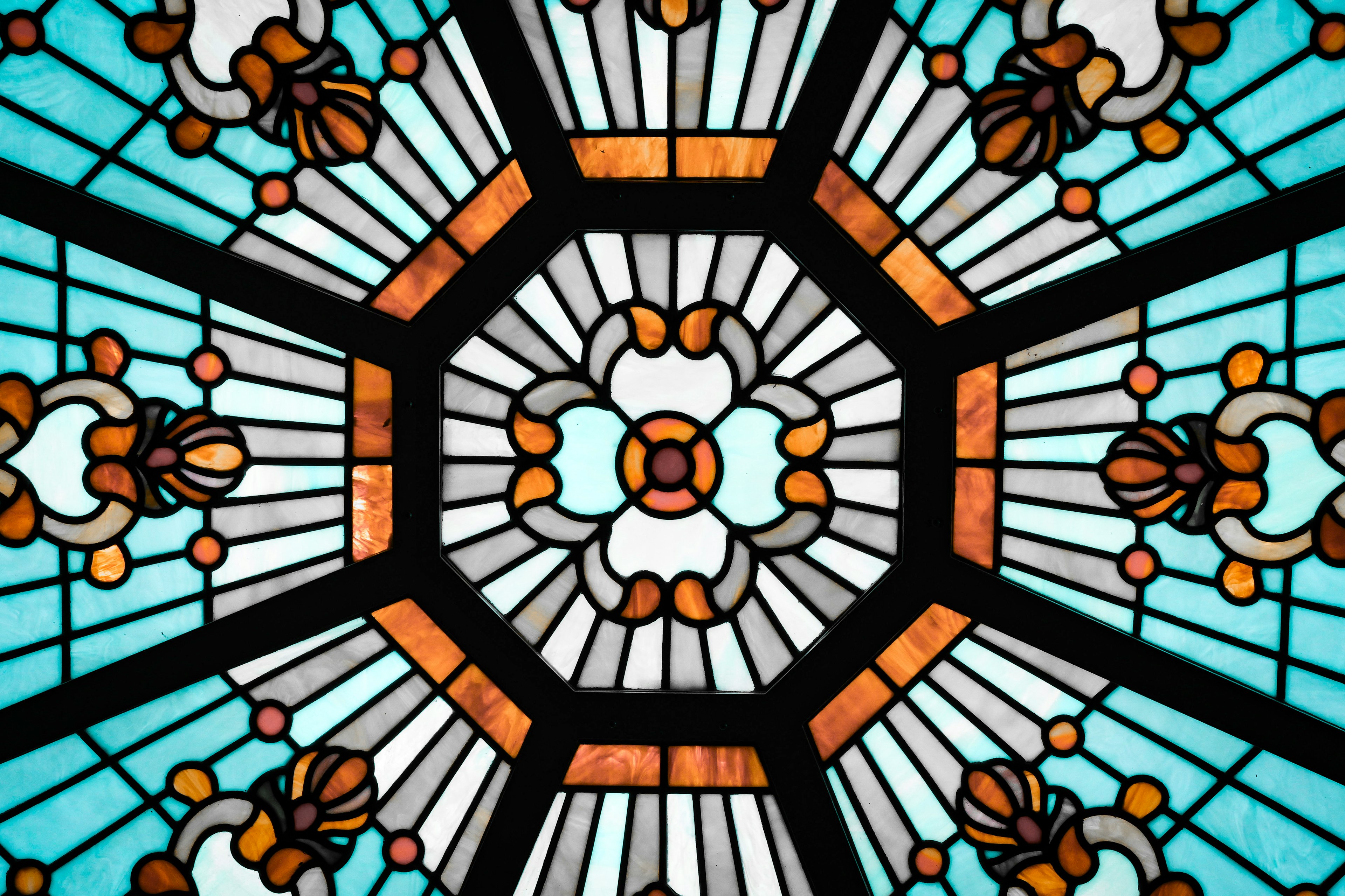 Beautiful stained glass design featuring an octagonal pattern with blue and orange hues