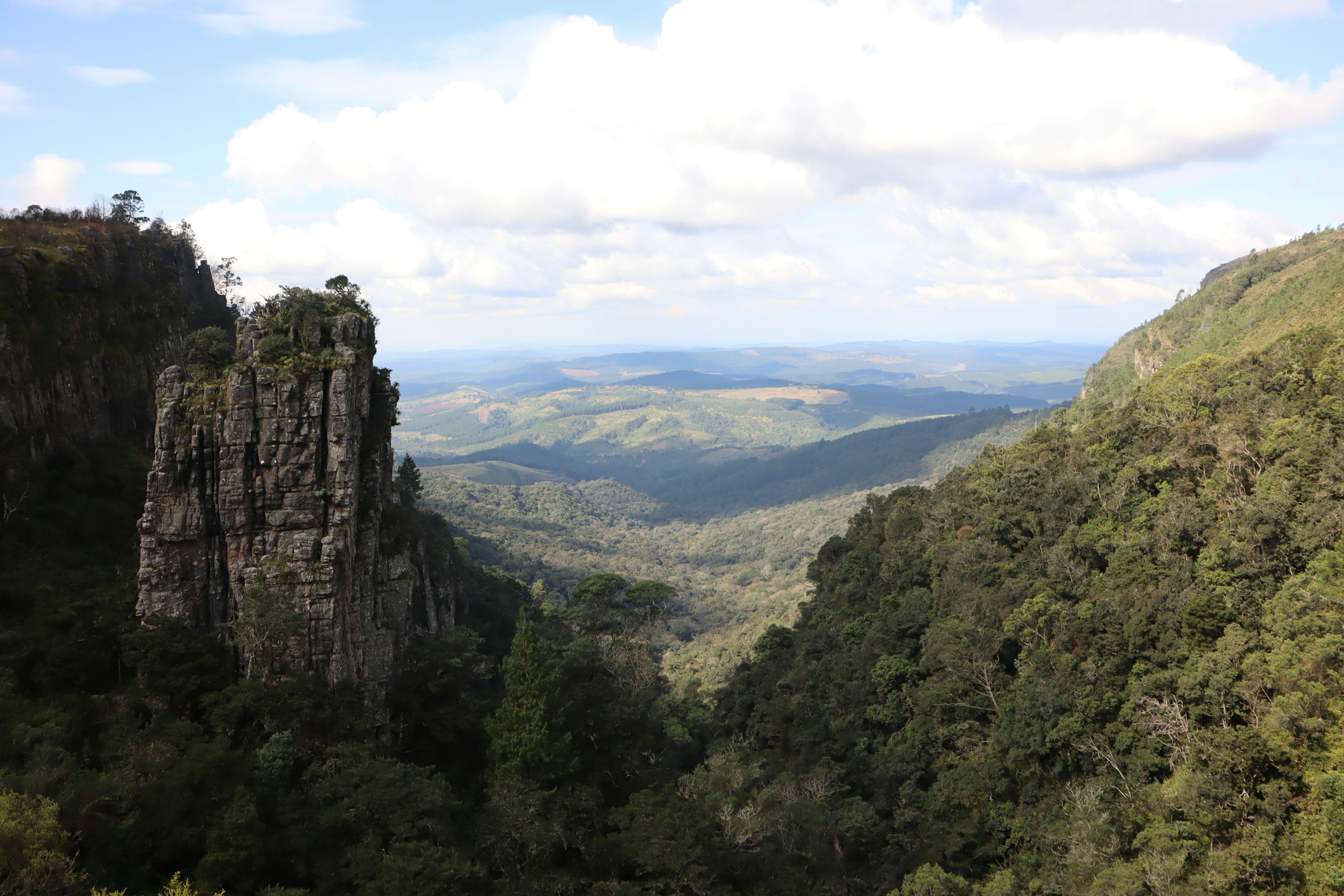 Majestic landscape featuring lush mountains and a prominent rock formation