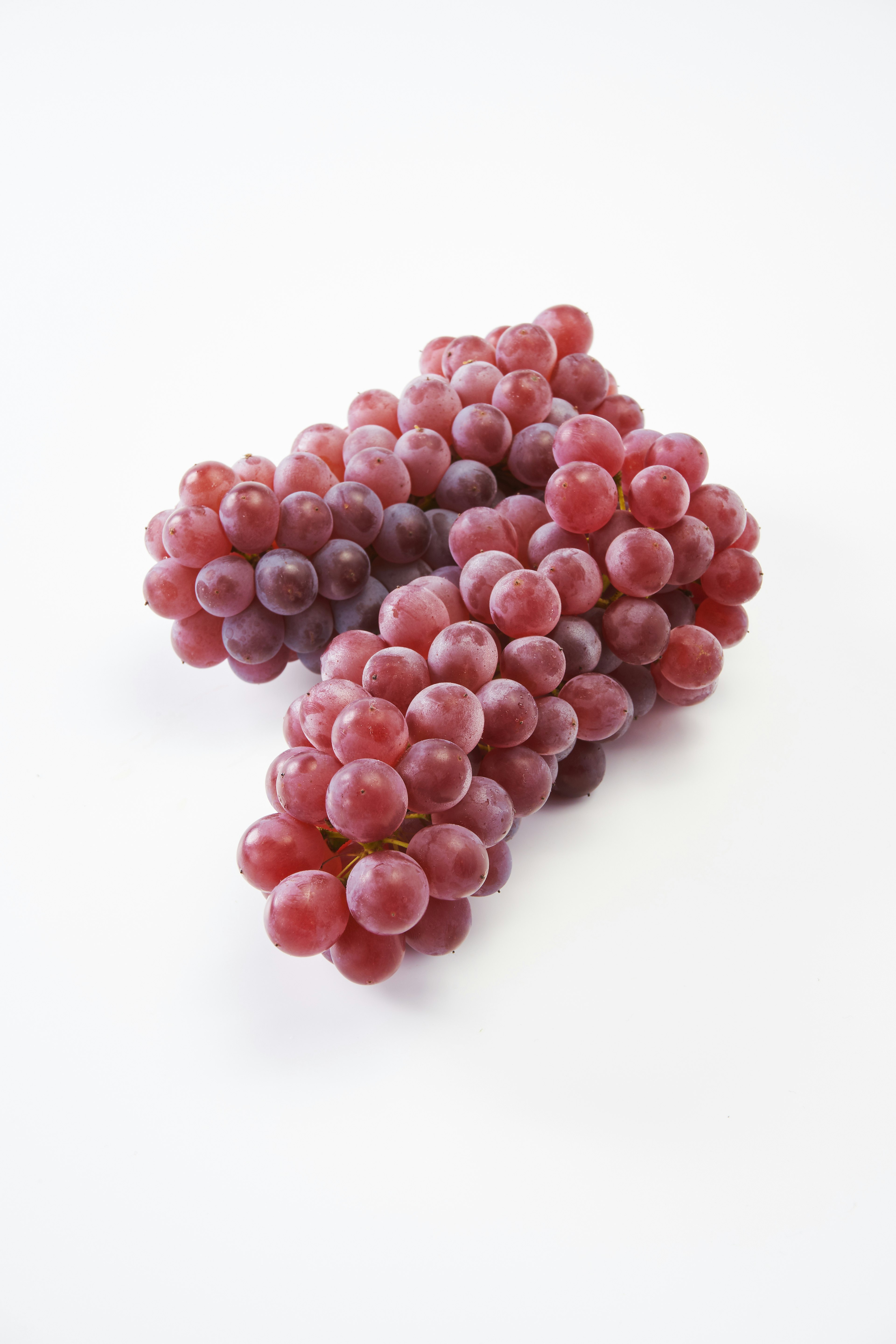 Bunches of red grapes on a white background