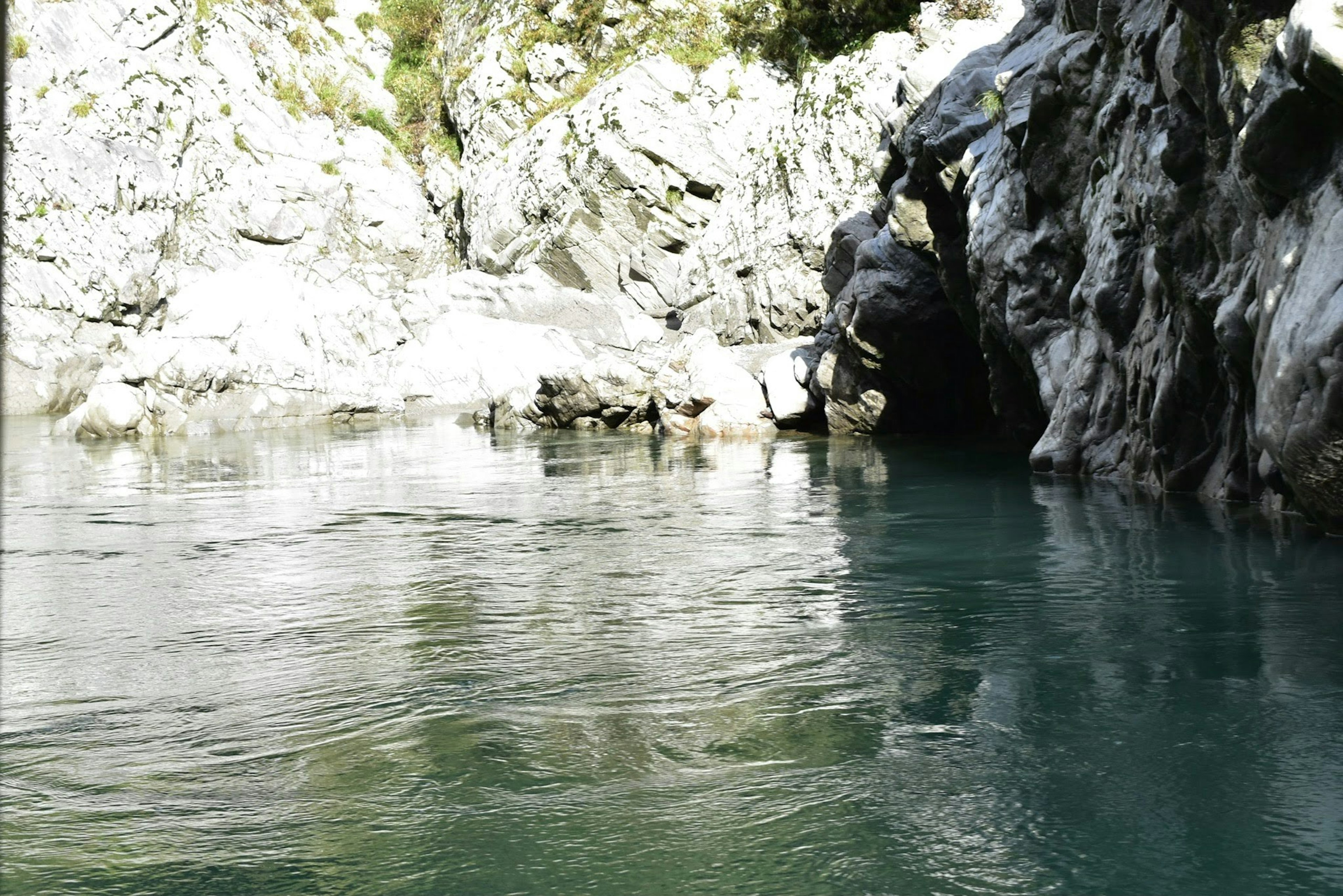 Serene river flowing surrounded by rocky cliffs