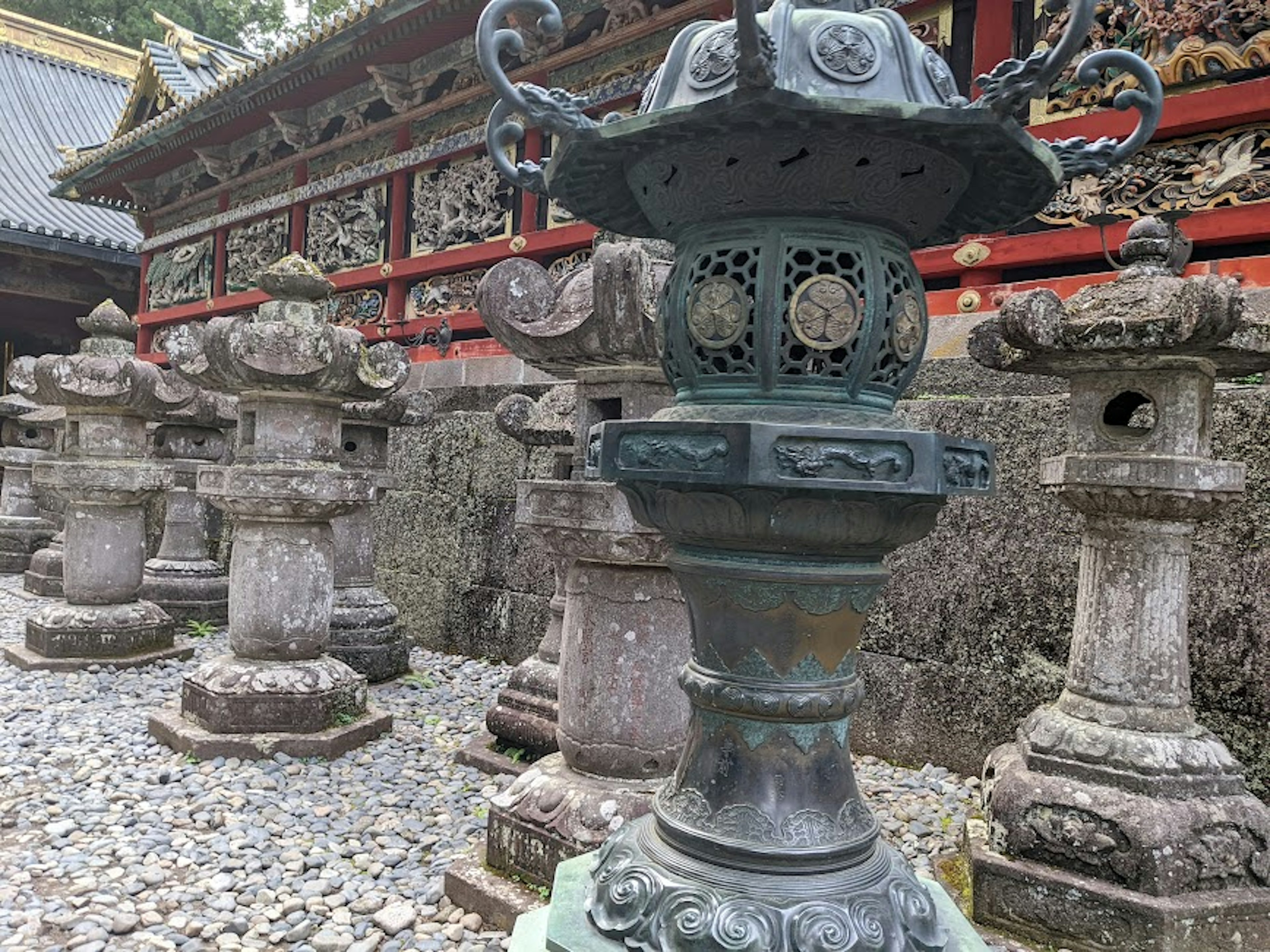 Old stone lanterns arranged in a temple courtyard