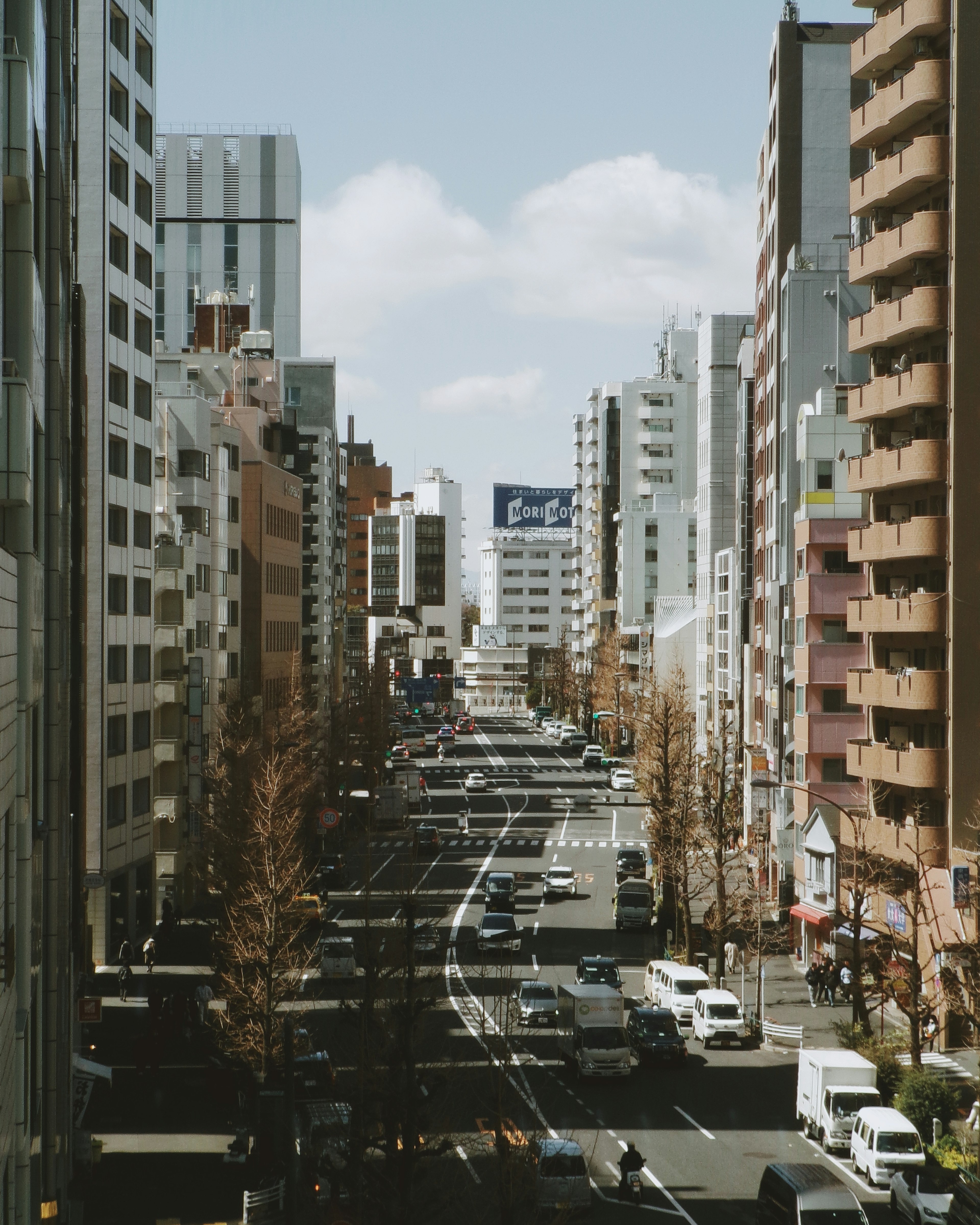 A view of a city street lined with tall buildings