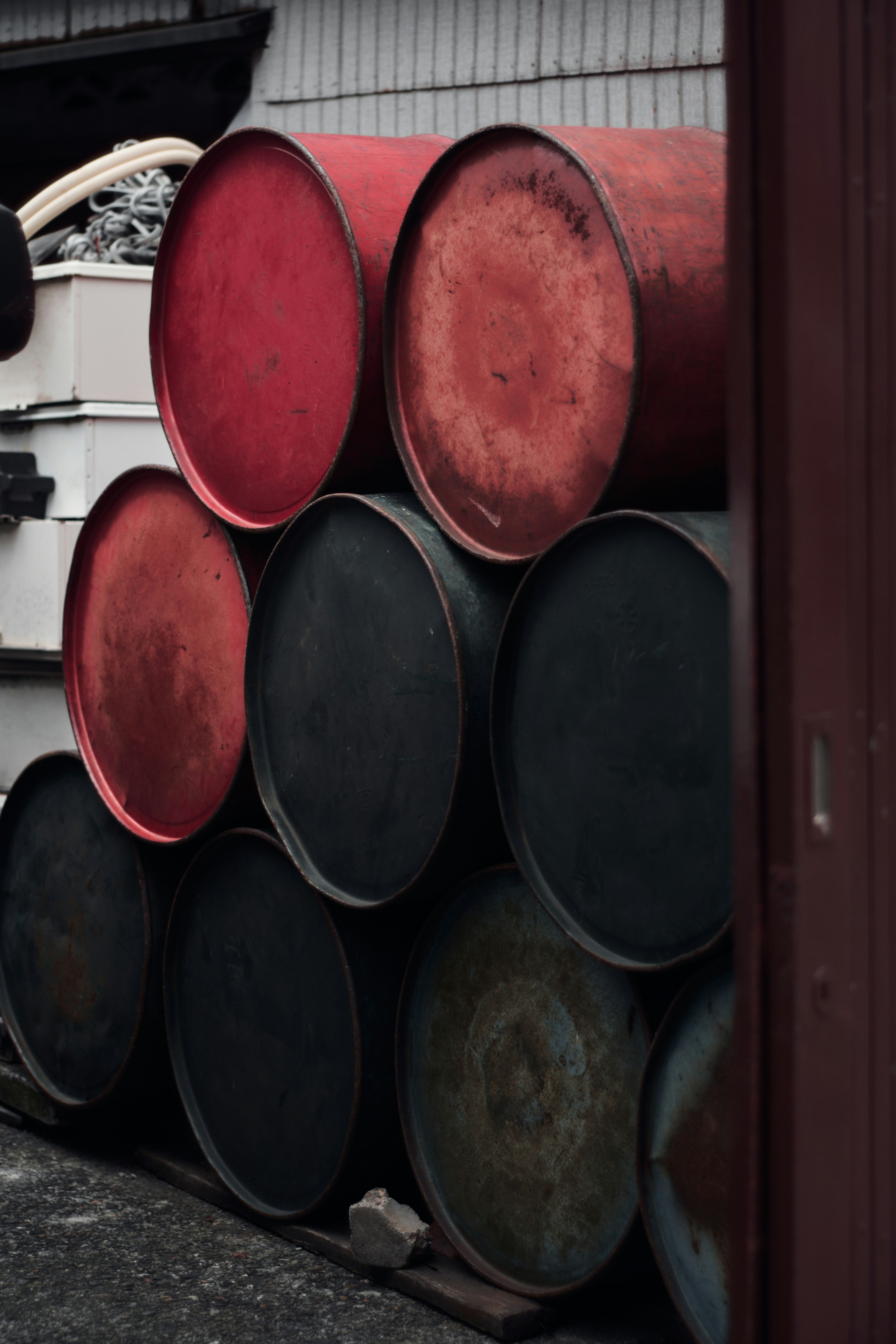 Stacked red and black drums in an industrial setting