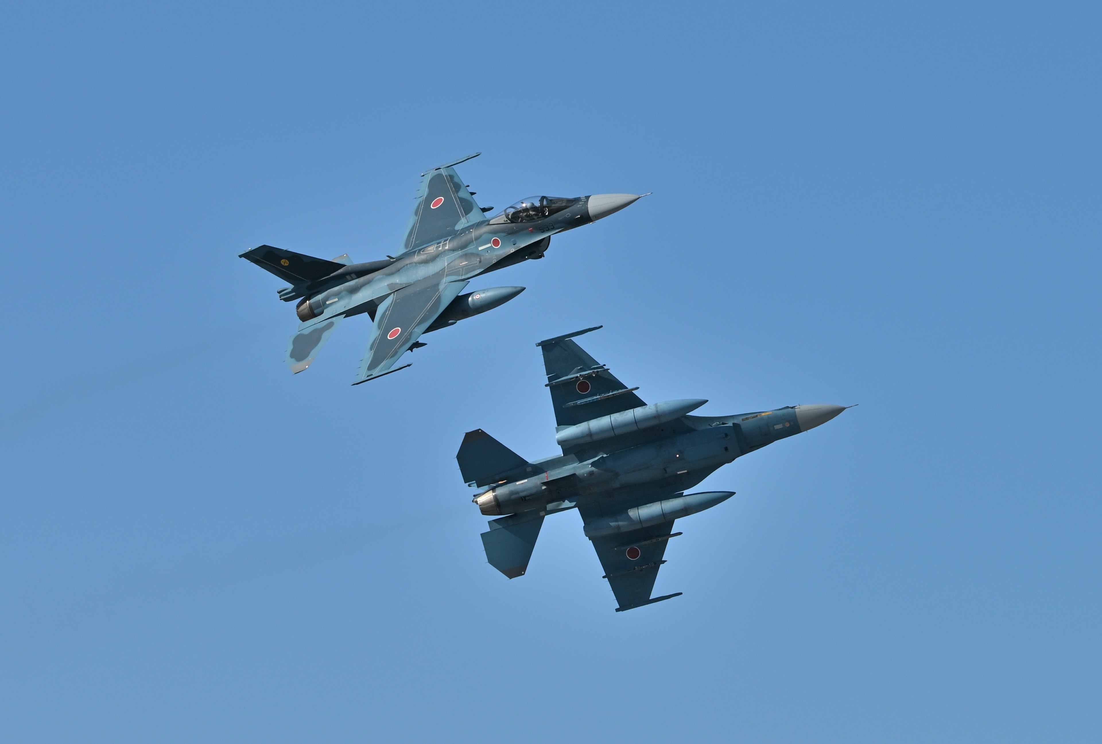 Dynamic view of two fighter jets flying in the sky