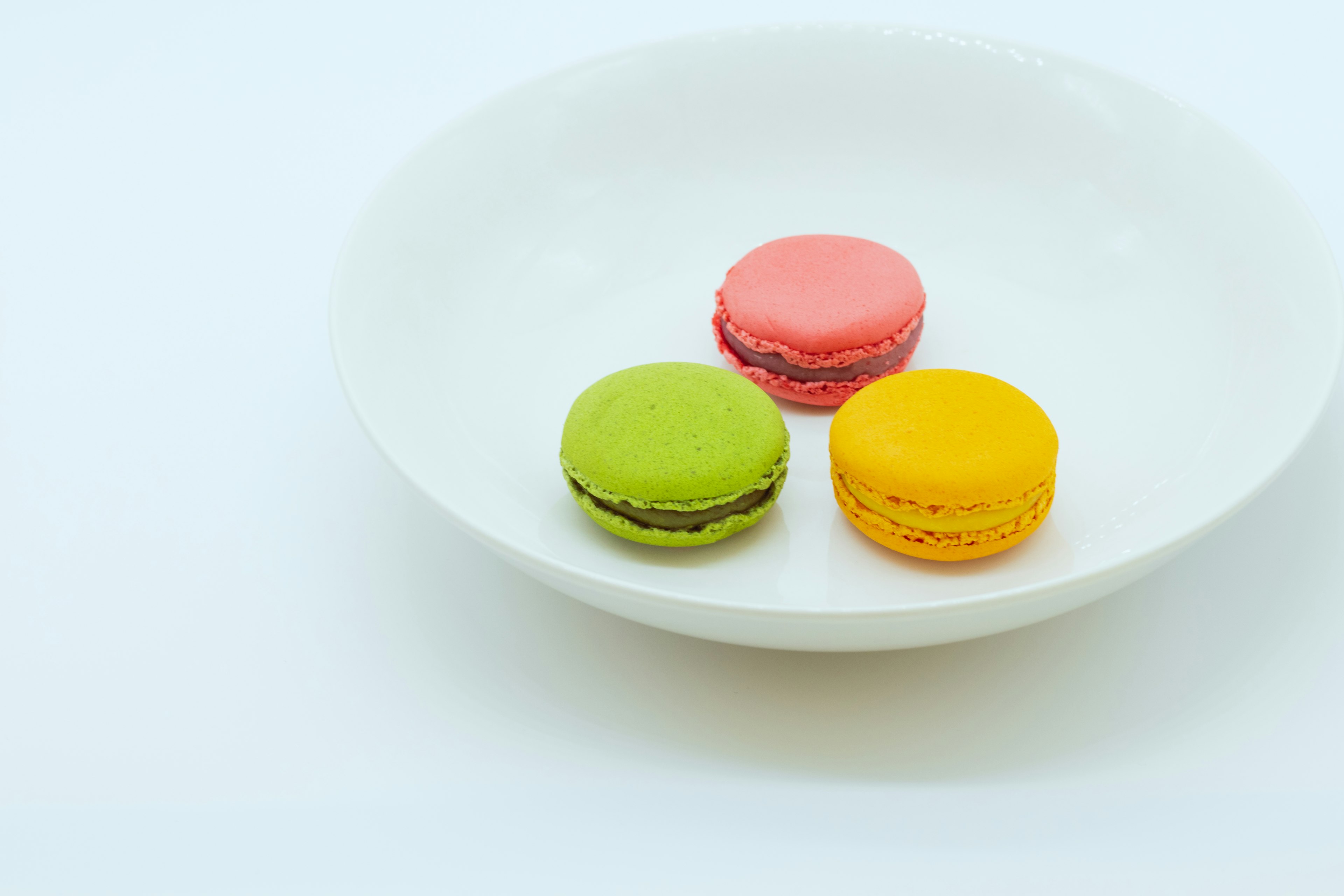 Colorful macarons on a white plate