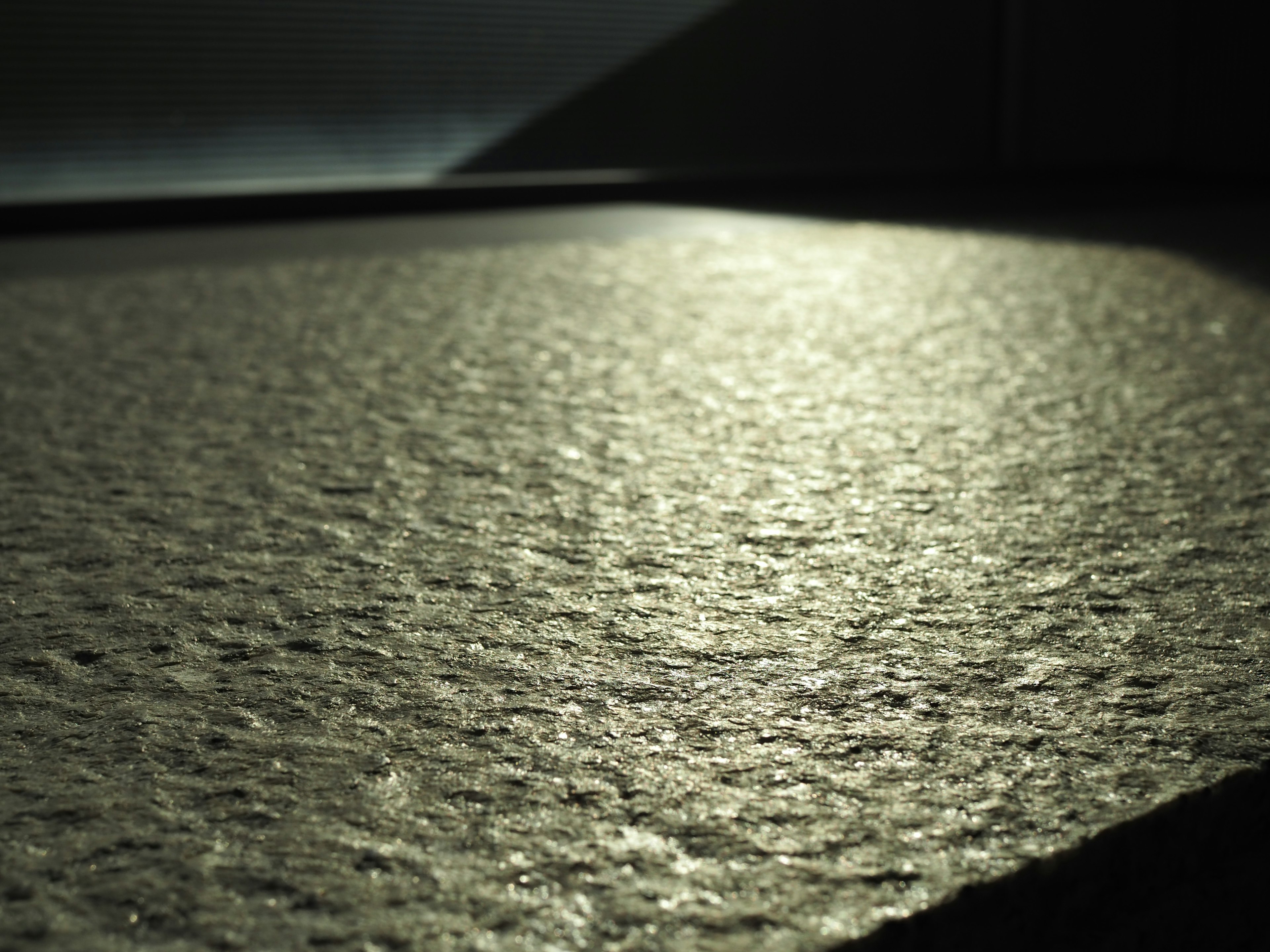 Image featuring a textured surface with reflective light