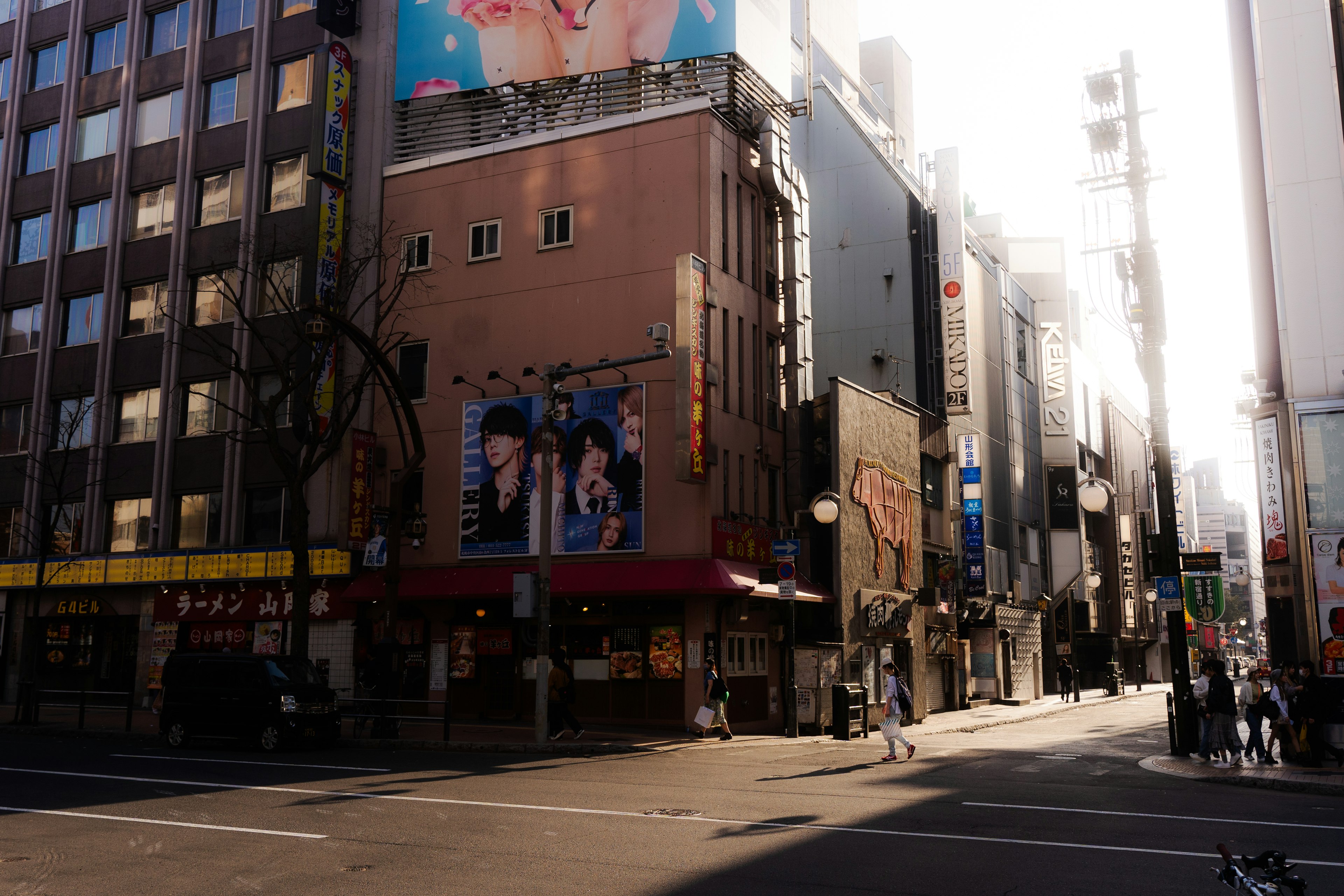 Urban intersection featuring buildings and advertisements