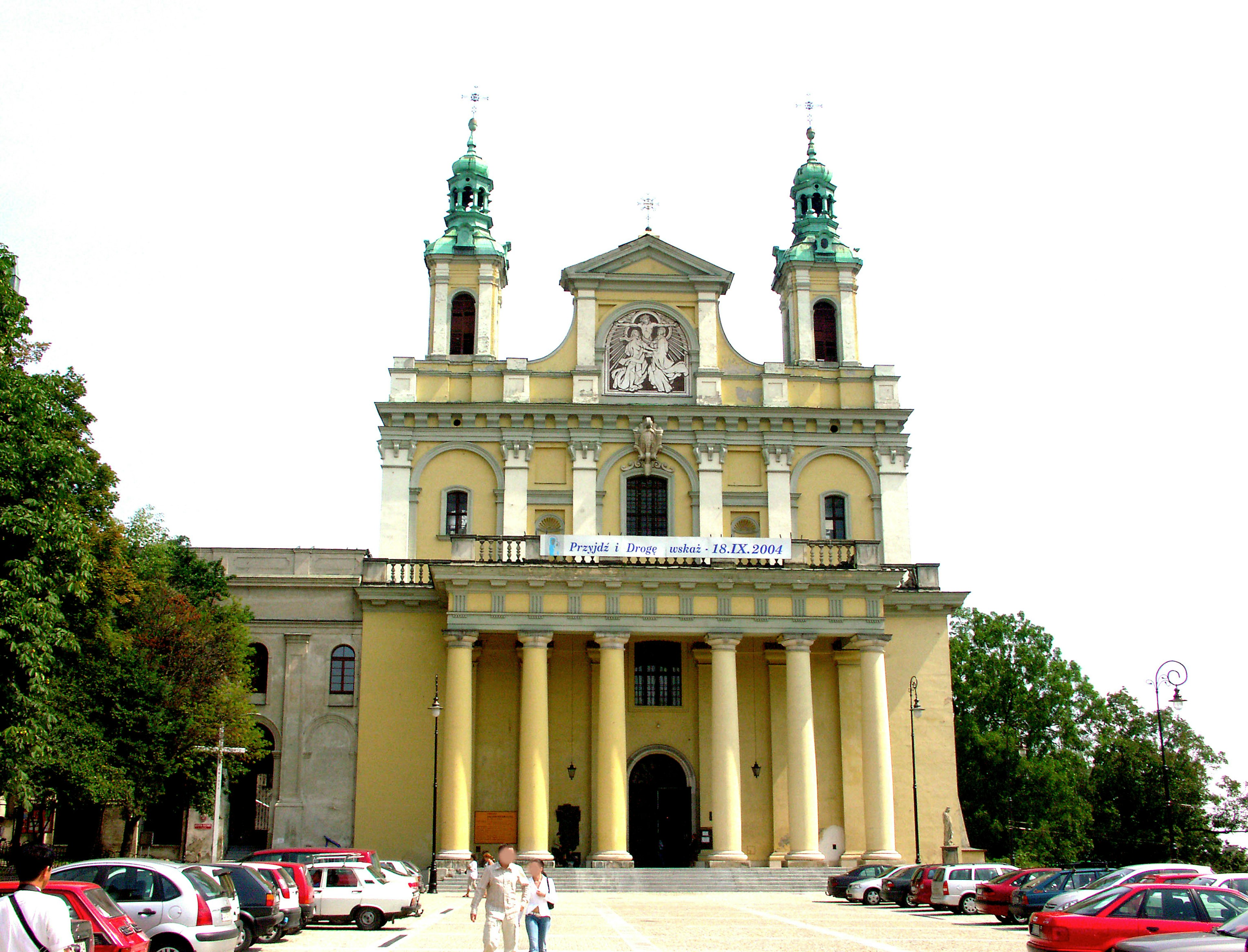 Beautiful church with yellow exterior and distinctive green spires