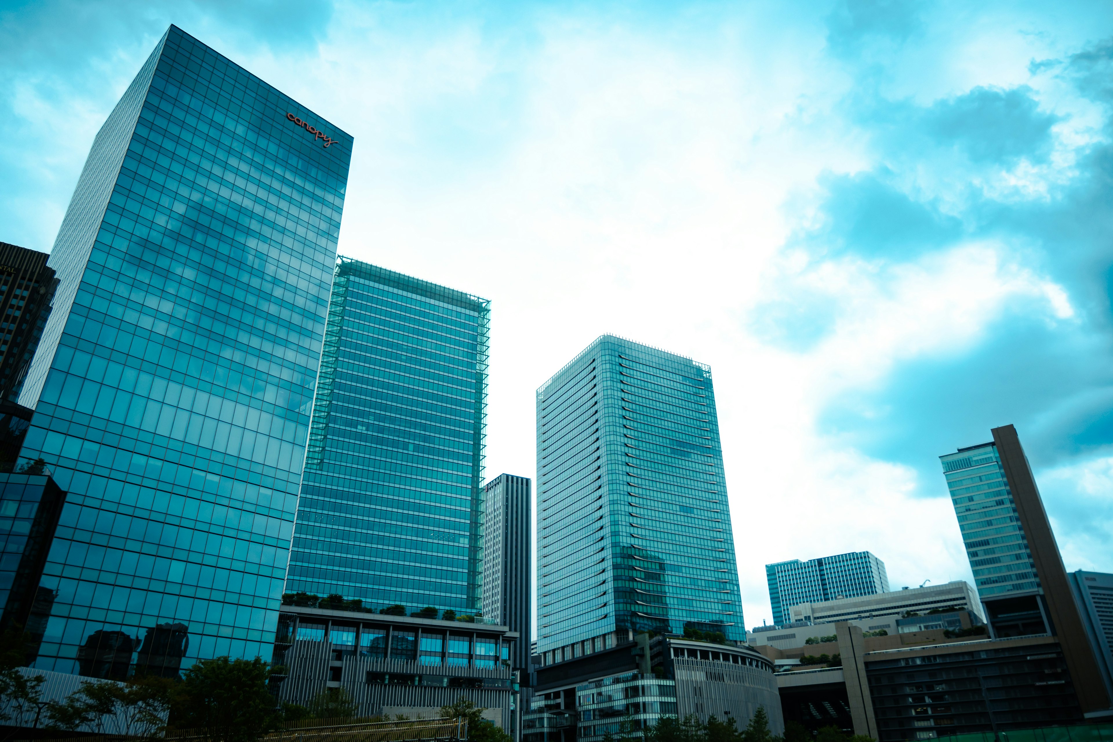 City skyline with modern glass skyscrapers under a bright sky