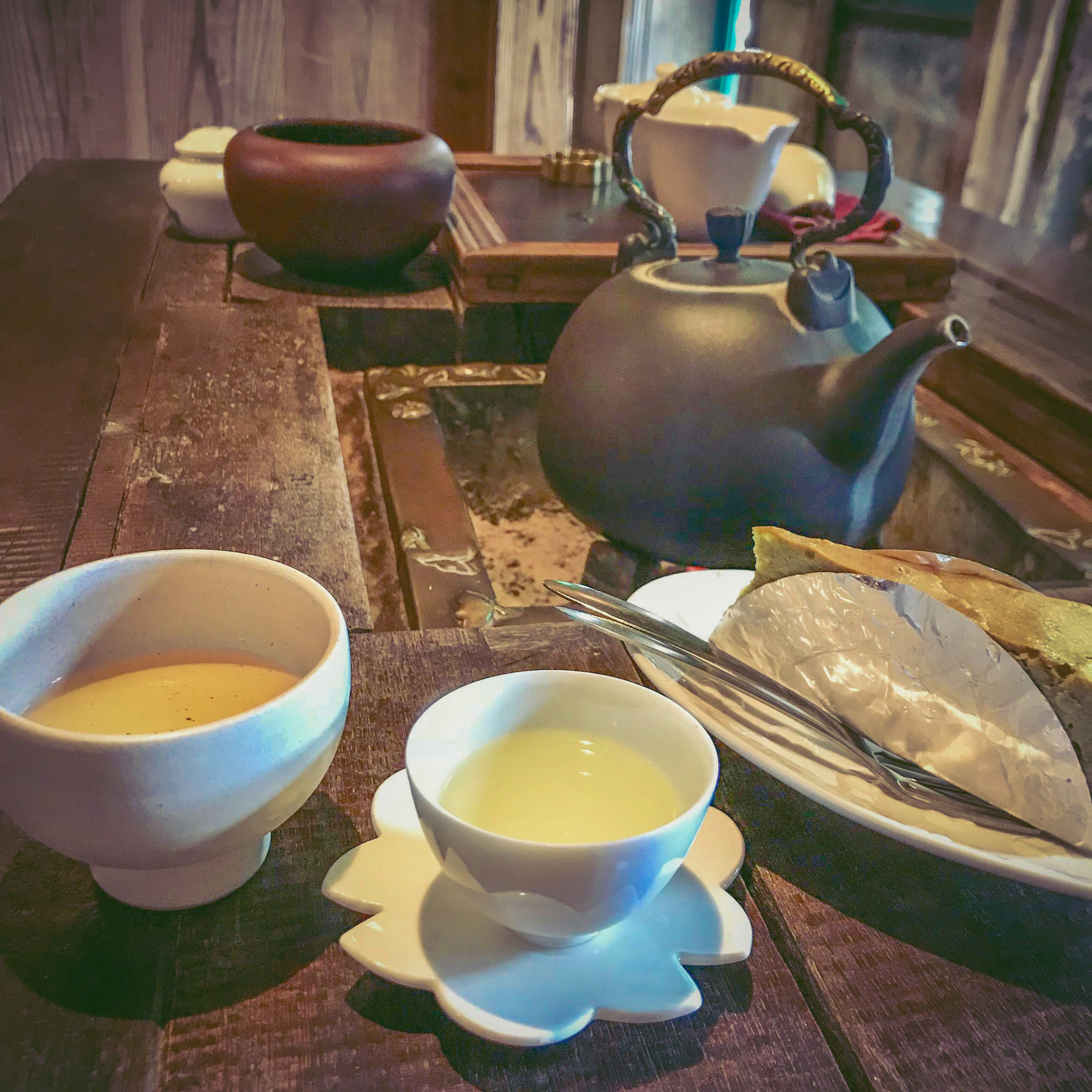 Table set with tea utensils and two teacups