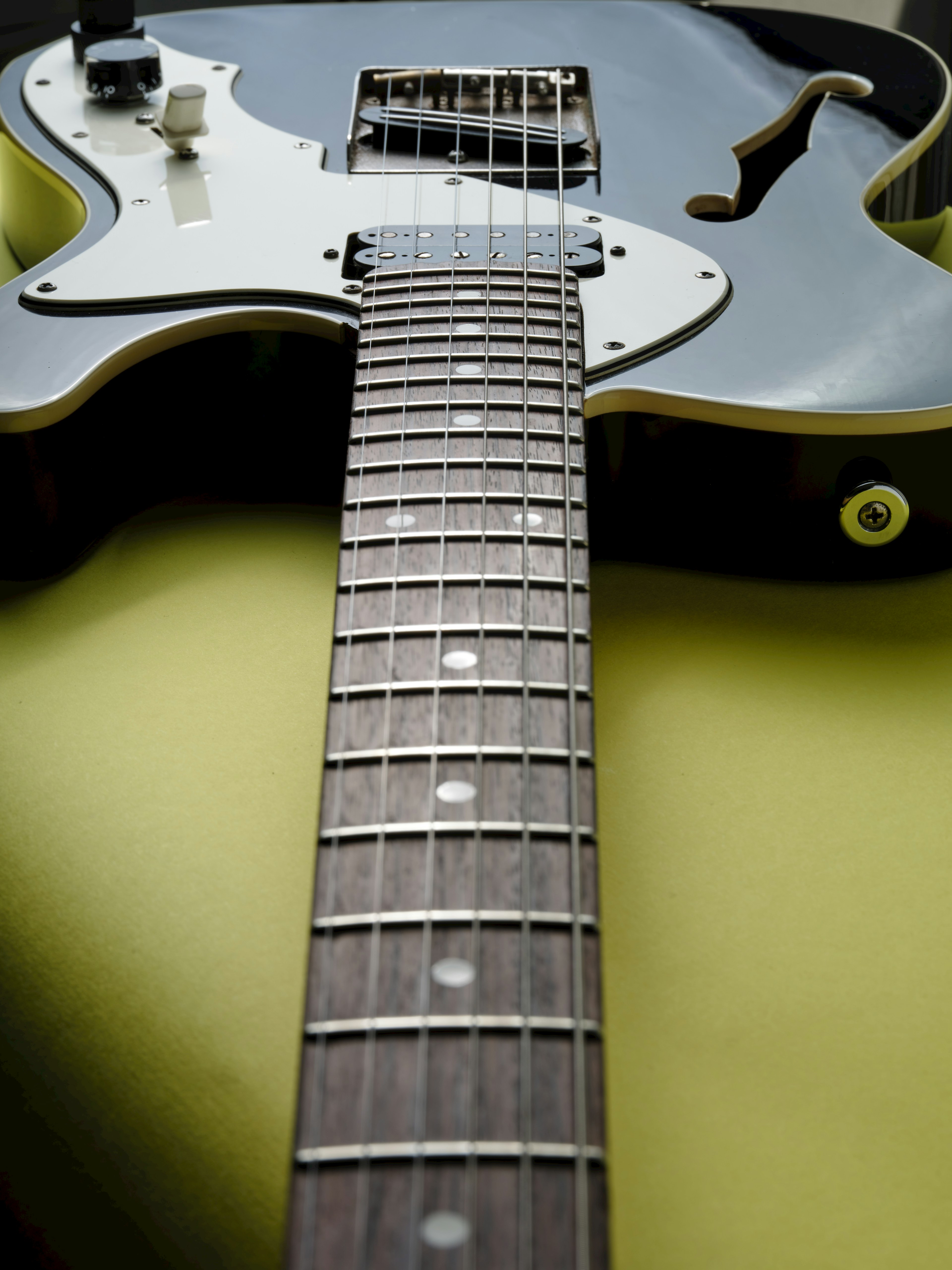 Close-up of a black electric guitar neck and body