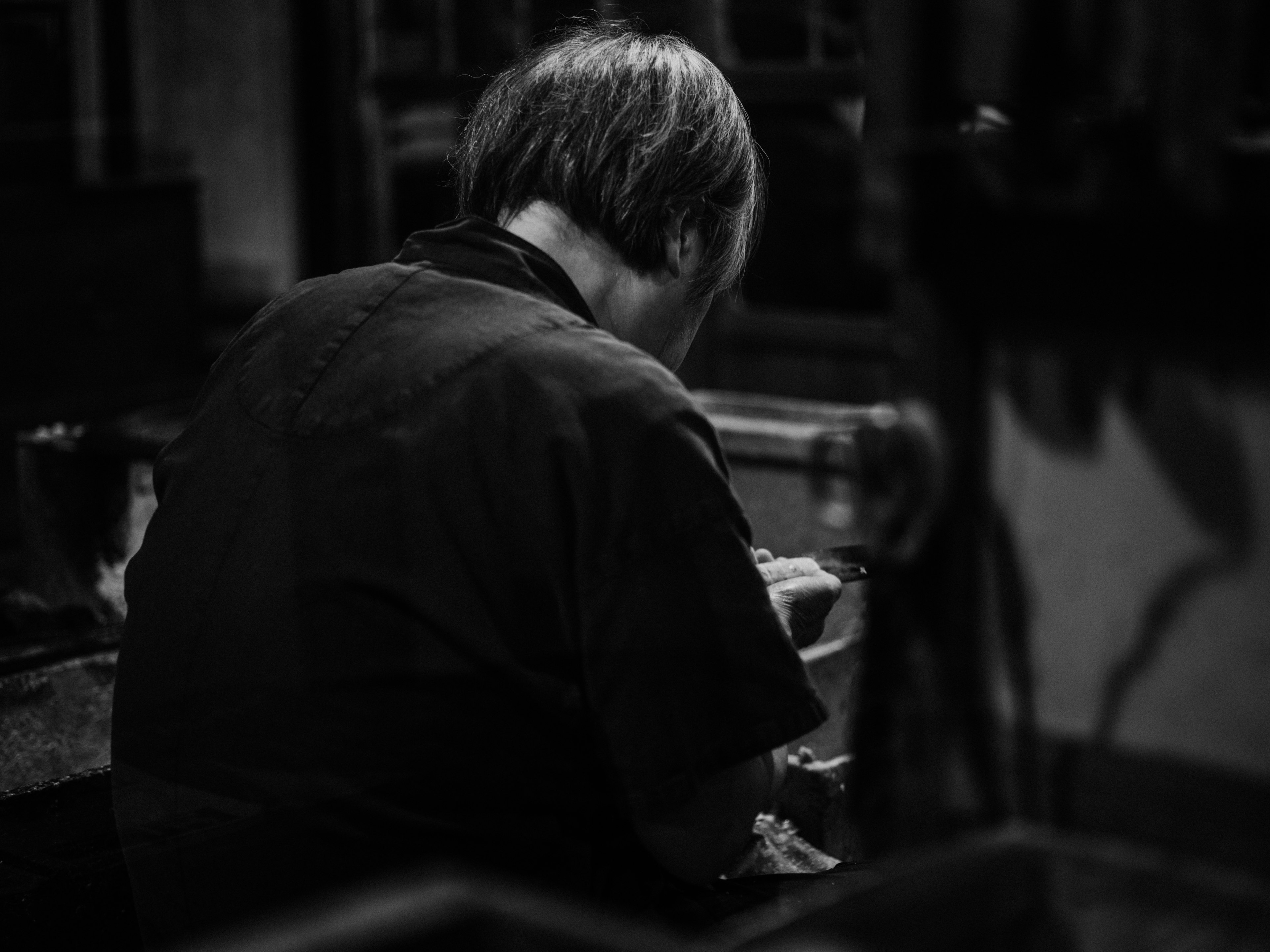 An artisan focused on work in a black and white image