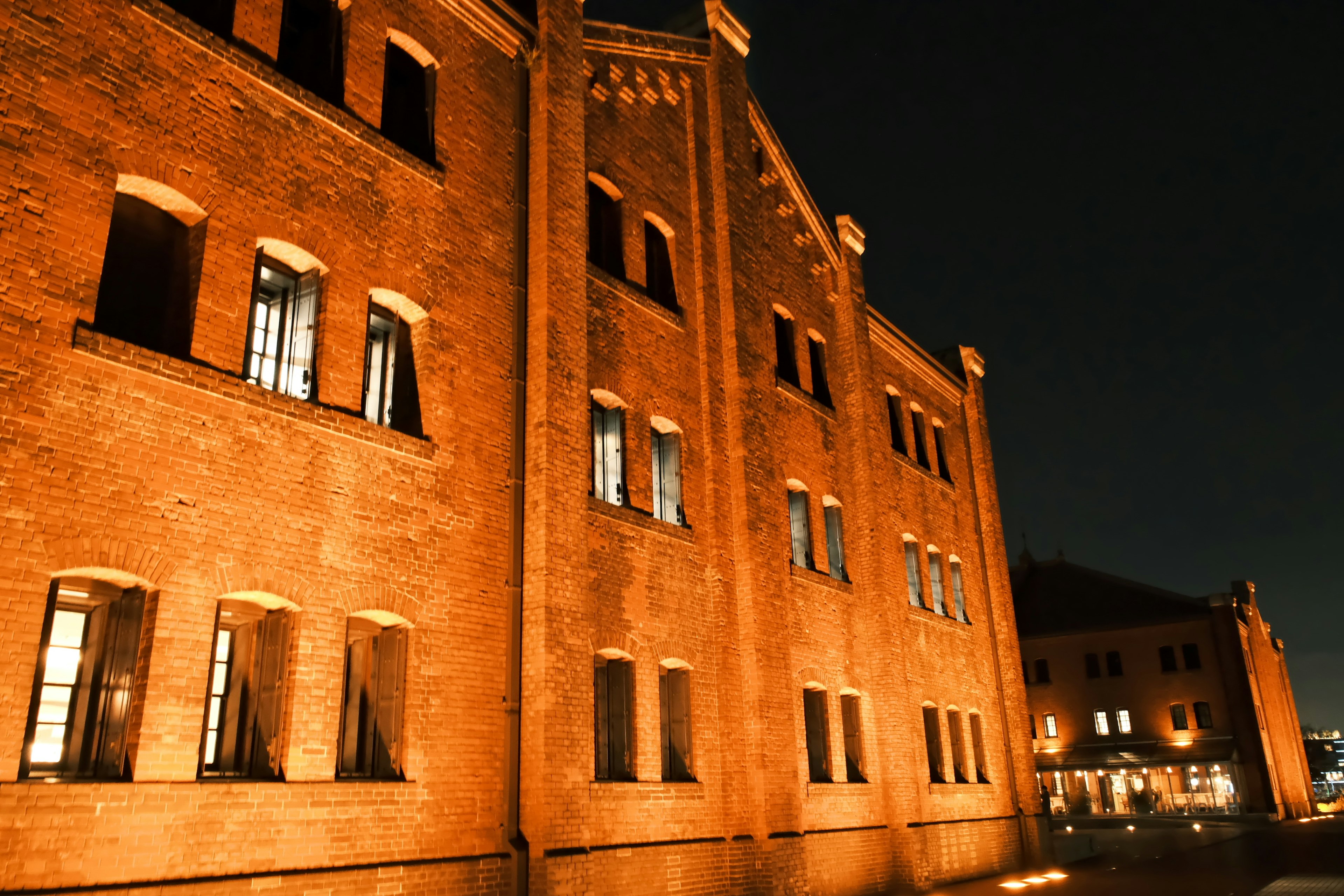 Exterior of a brick building illuminated at night