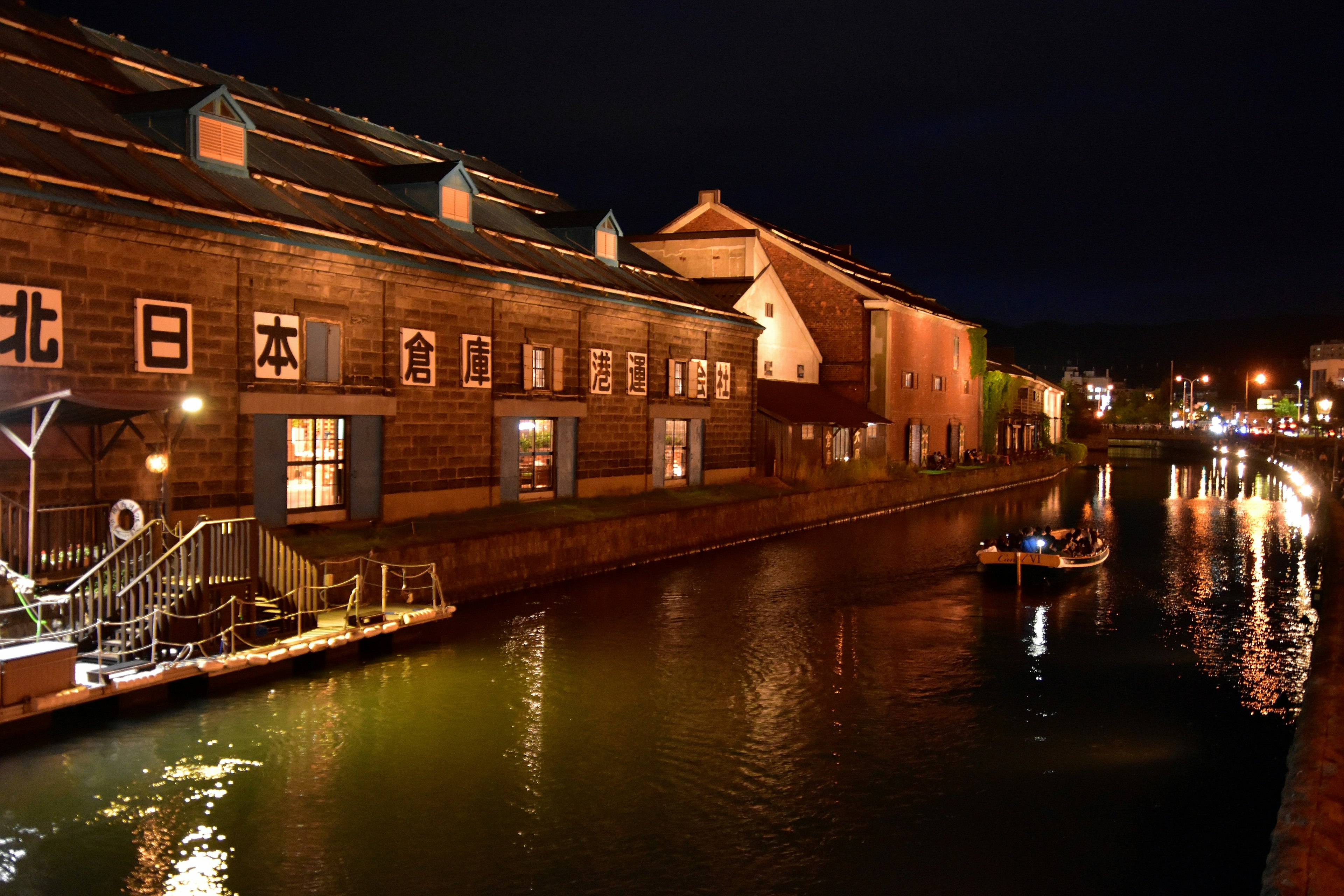 Historic warehouses along a canal at night