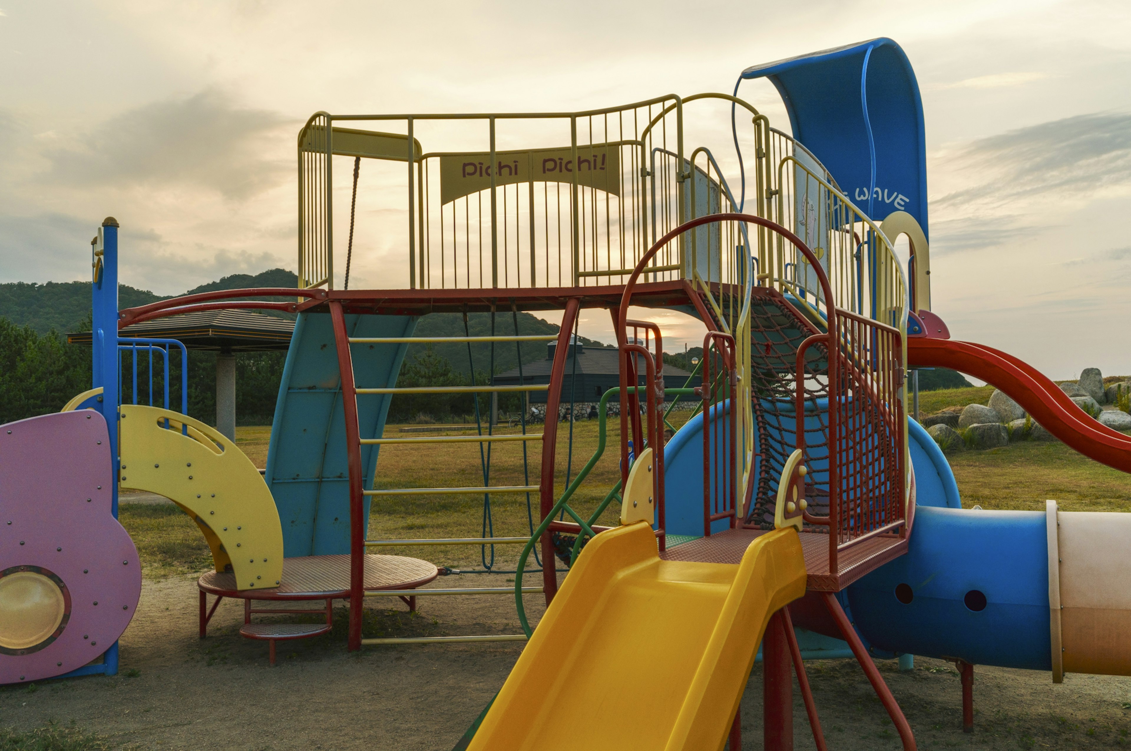 Colorful playground structure with a slide and climbing area