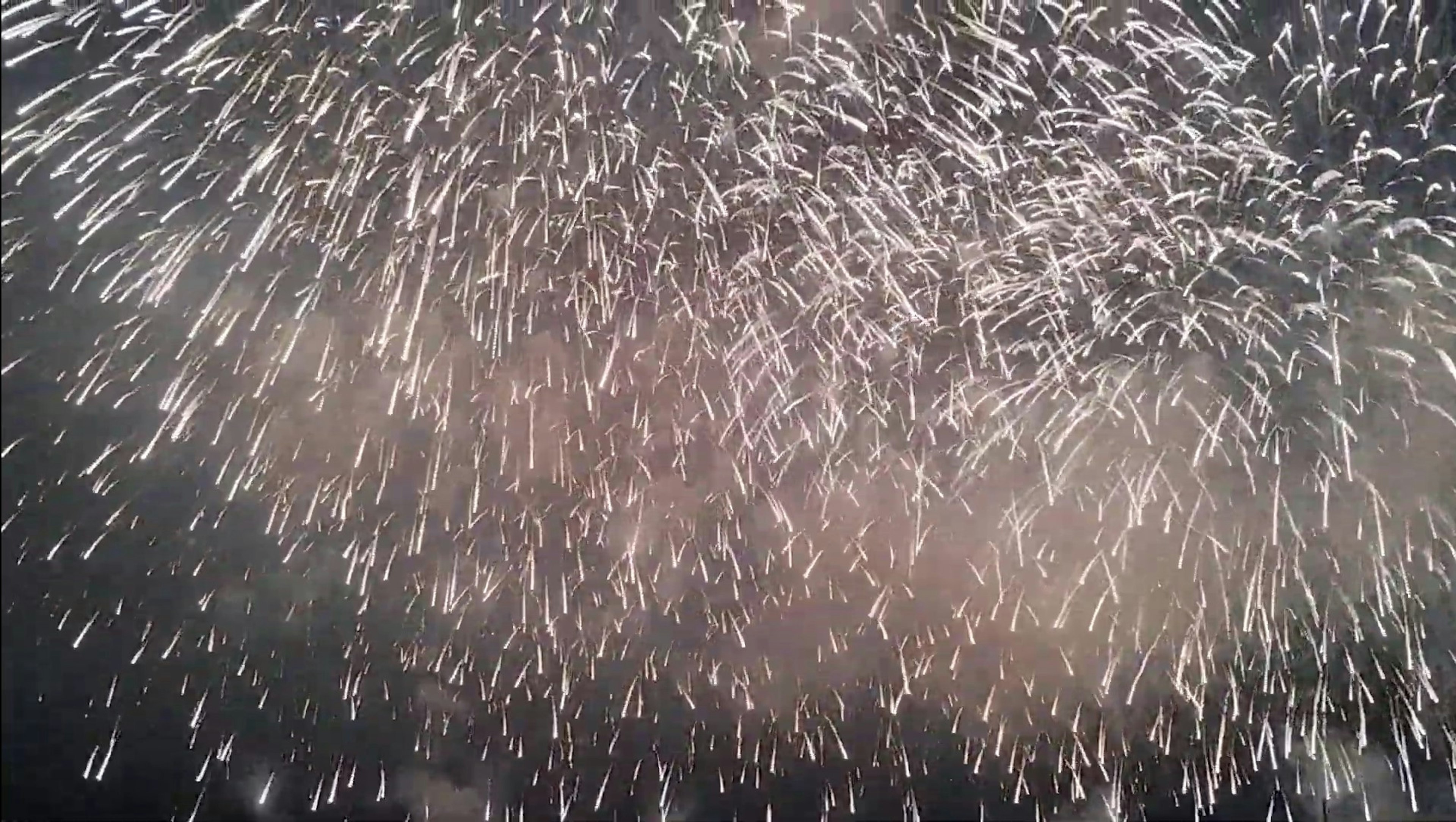 Burst of sparkling lights resembling fireworks in the night sky