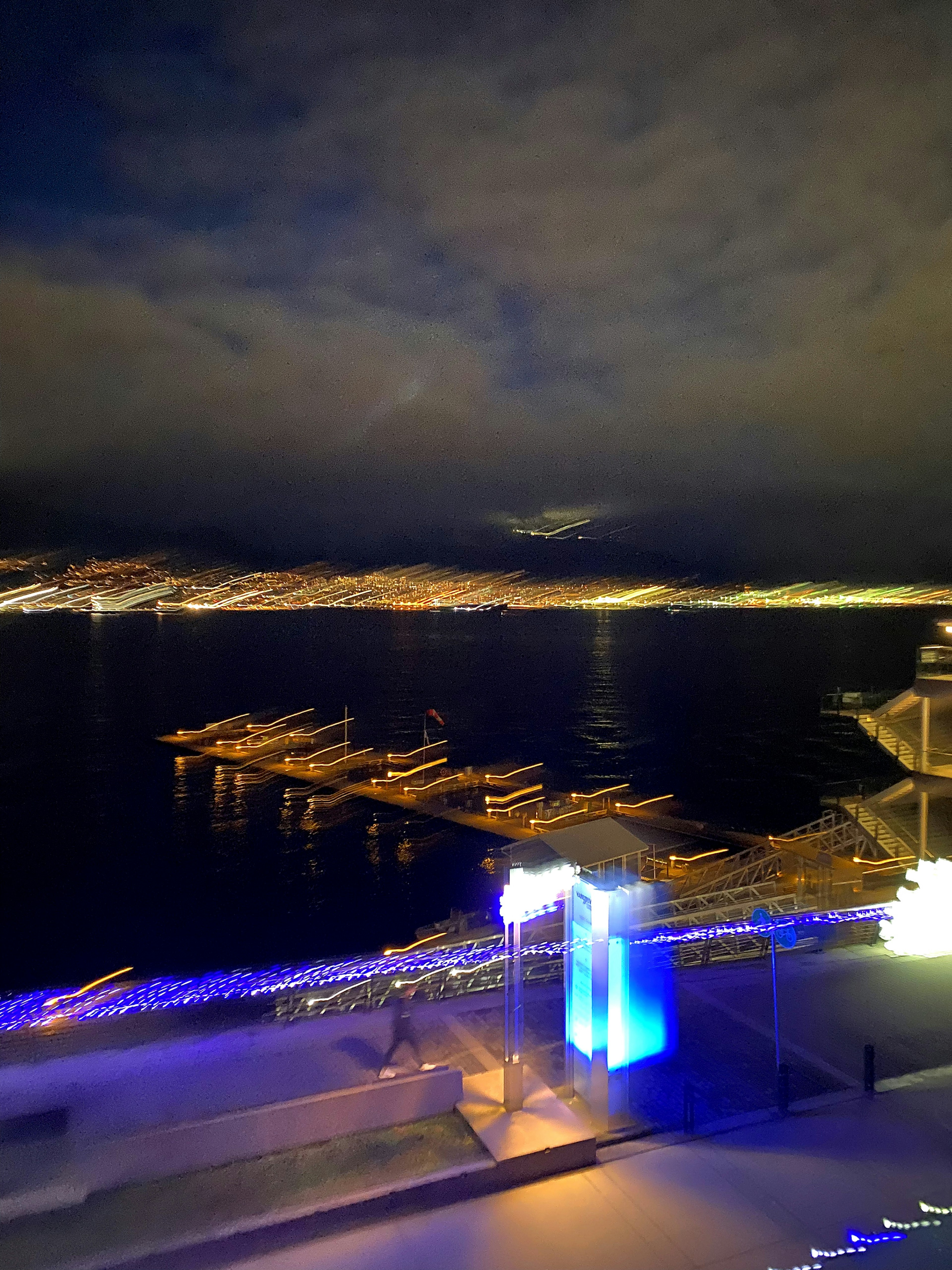 Vista sfocata di un porto notturno con luci e barche