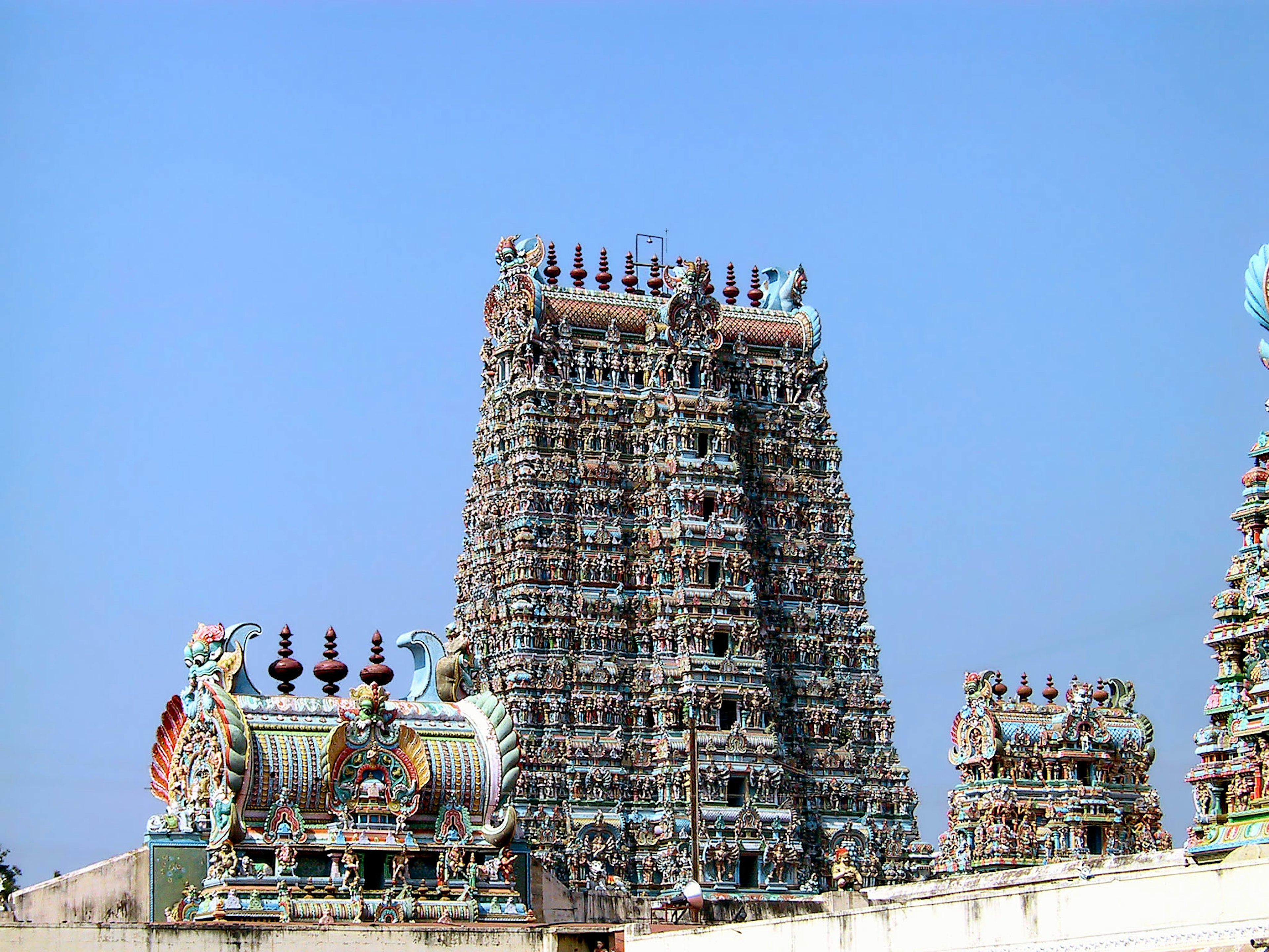 Colorful South Indian temple tower soaring under a blue sky