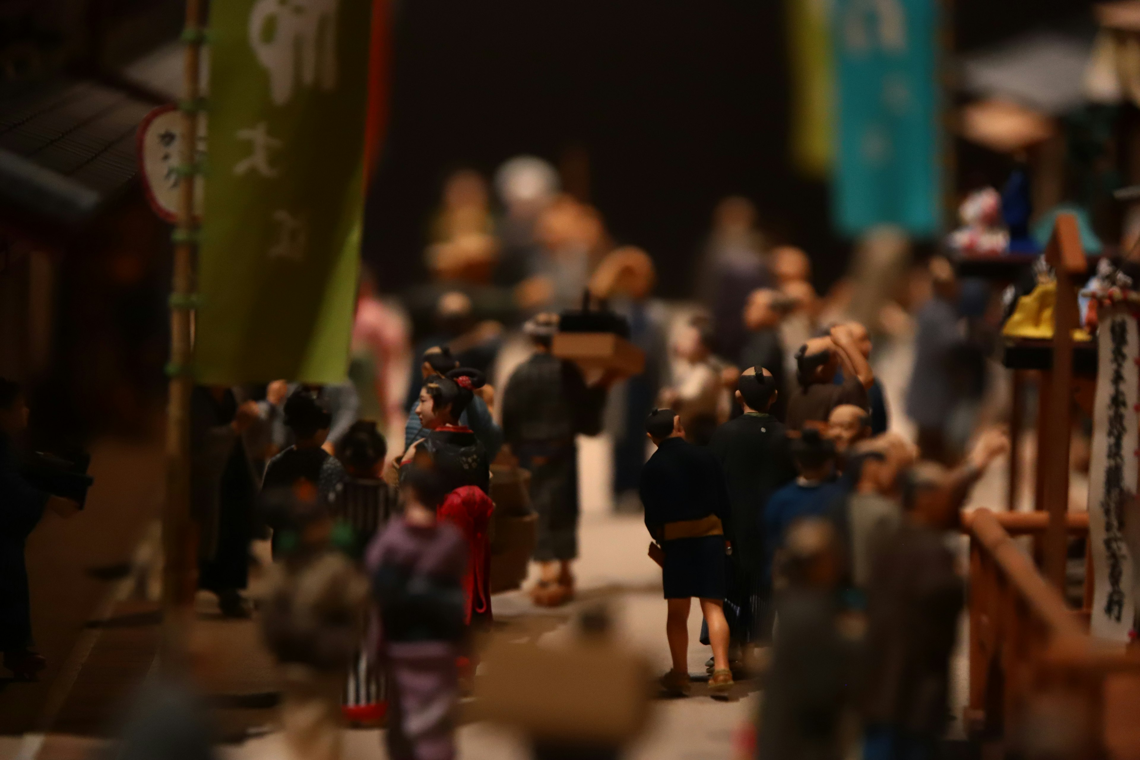 Scene of miniature street with people walking colorful flags in the background